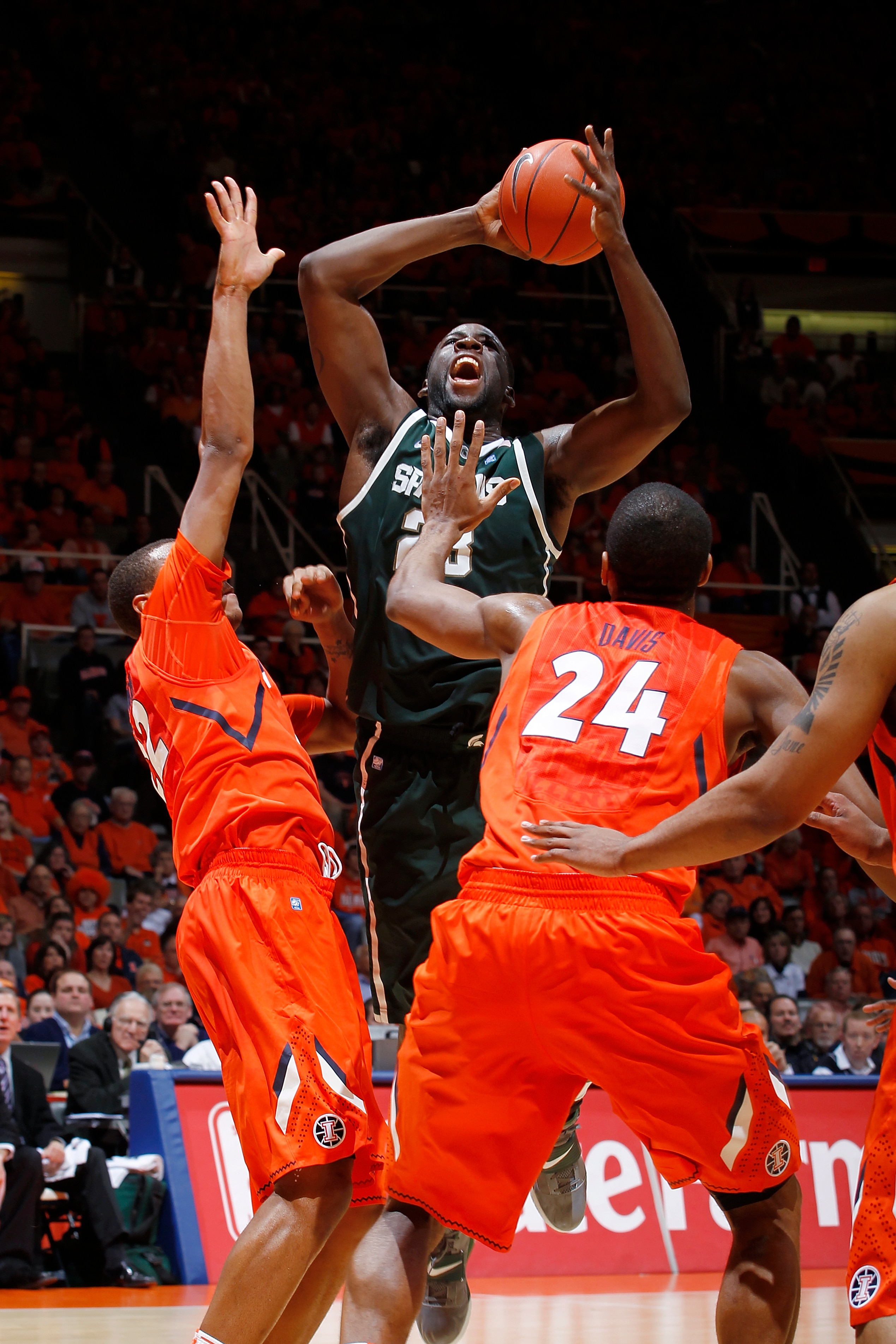 CHAMPAIGN, IL - JANUARY 18: Jereme Richmond #22 and Mike Davis #24 of the Illinois Fighting Illini defend a shot by Draymond Green #23 of the Michigan State Spartans at Assembly Hall on January 18, 2011 in Champaign, Illinois. Illinois defeated Michigan S