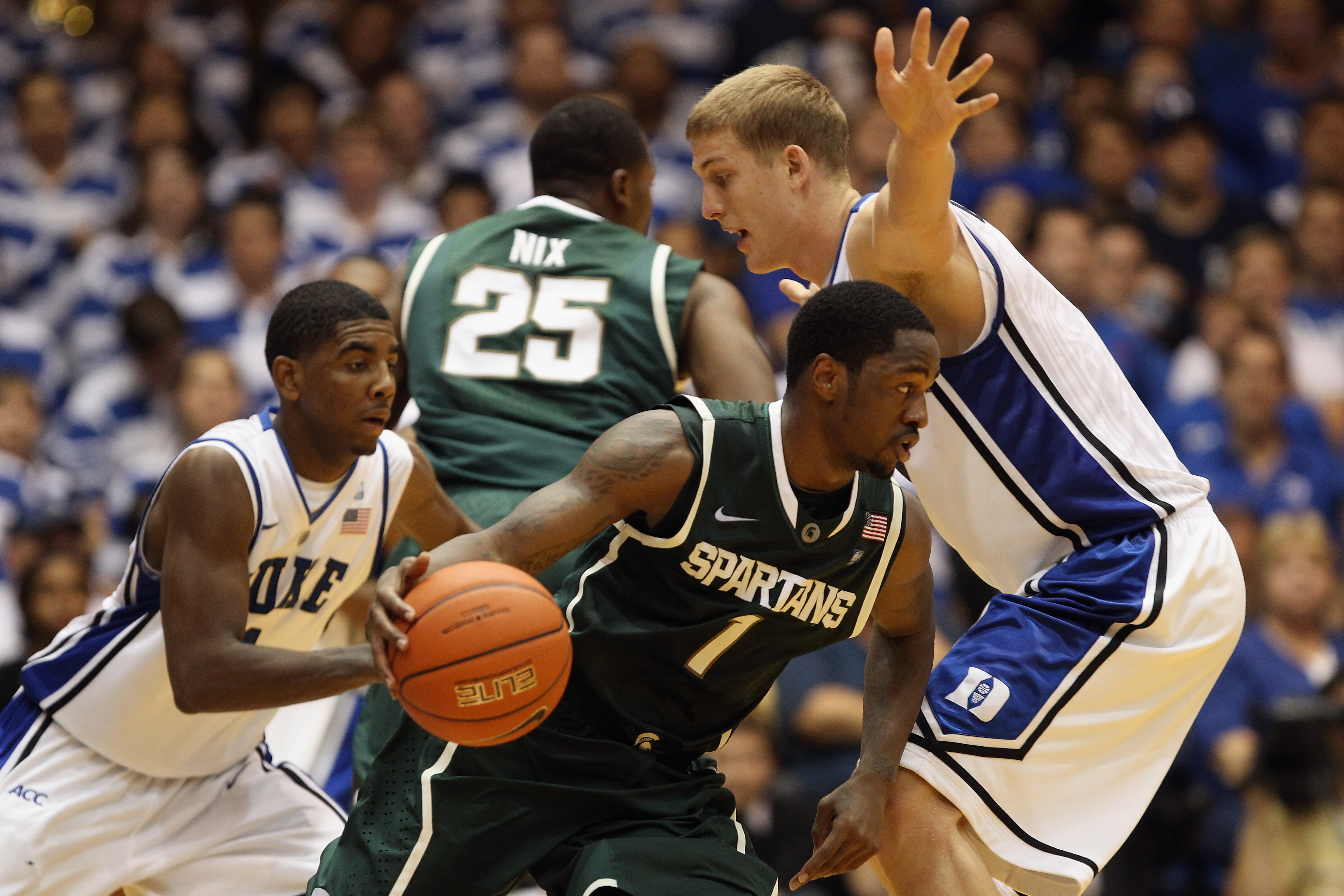DURHAM, NC - DECEMBER 01:  Kalin Lucas #1 of the Michigan State Spartans tries to dribble out of a trap by Kyrie Irving #1 and Mason Plumlee #5 of the Duke Blue Devils during their game at Cameron Indoor Stadium on December 1, 2010 in Durham, North Caroli