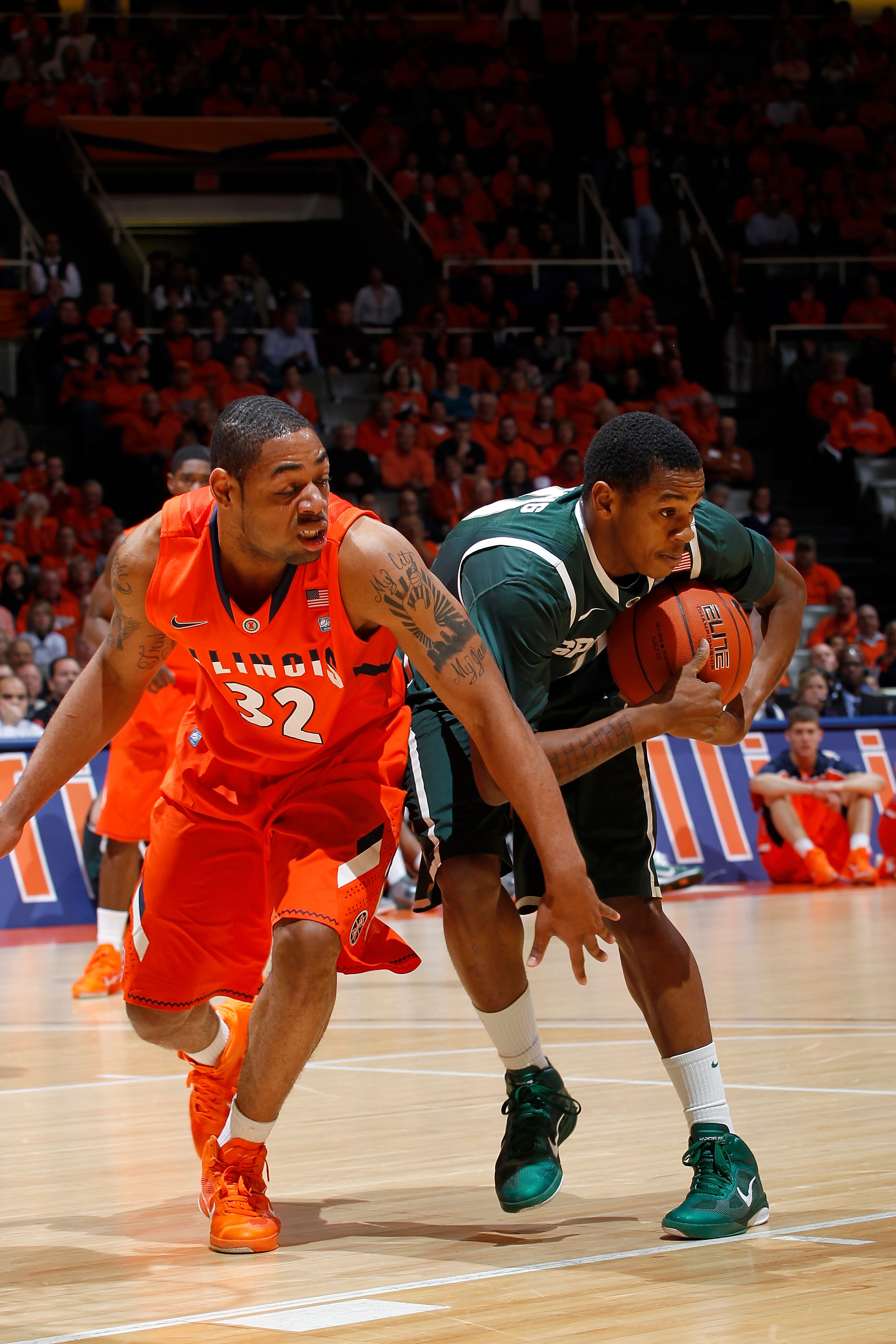 CHAMPAIGN, IL - JANUARY 18: Demetri McCamey #32 of the Illinois Fighting Illini goes for a loose ball against Keith Appling #11 of the Michigan State Spartans at Assembly Hall on January 18, 2011 in Champaign, Illinois. Illinois defeated Michigan State 71