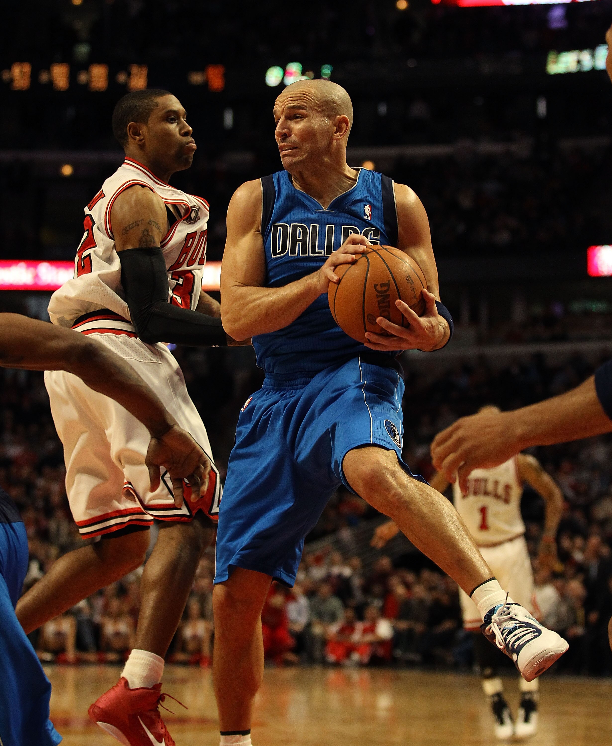 CHICAGO, IL - JANUARY 20: Jason Kidd #2 of the Dallas Mavericks grabs a rebound in front of C.J. Watson #32 of the Chicago Bulls at the United Center on January 20, 2011 in Chicago, Illinois. The Bulls defeated the Mavericks 82-77. NOTE TO USER: User expr