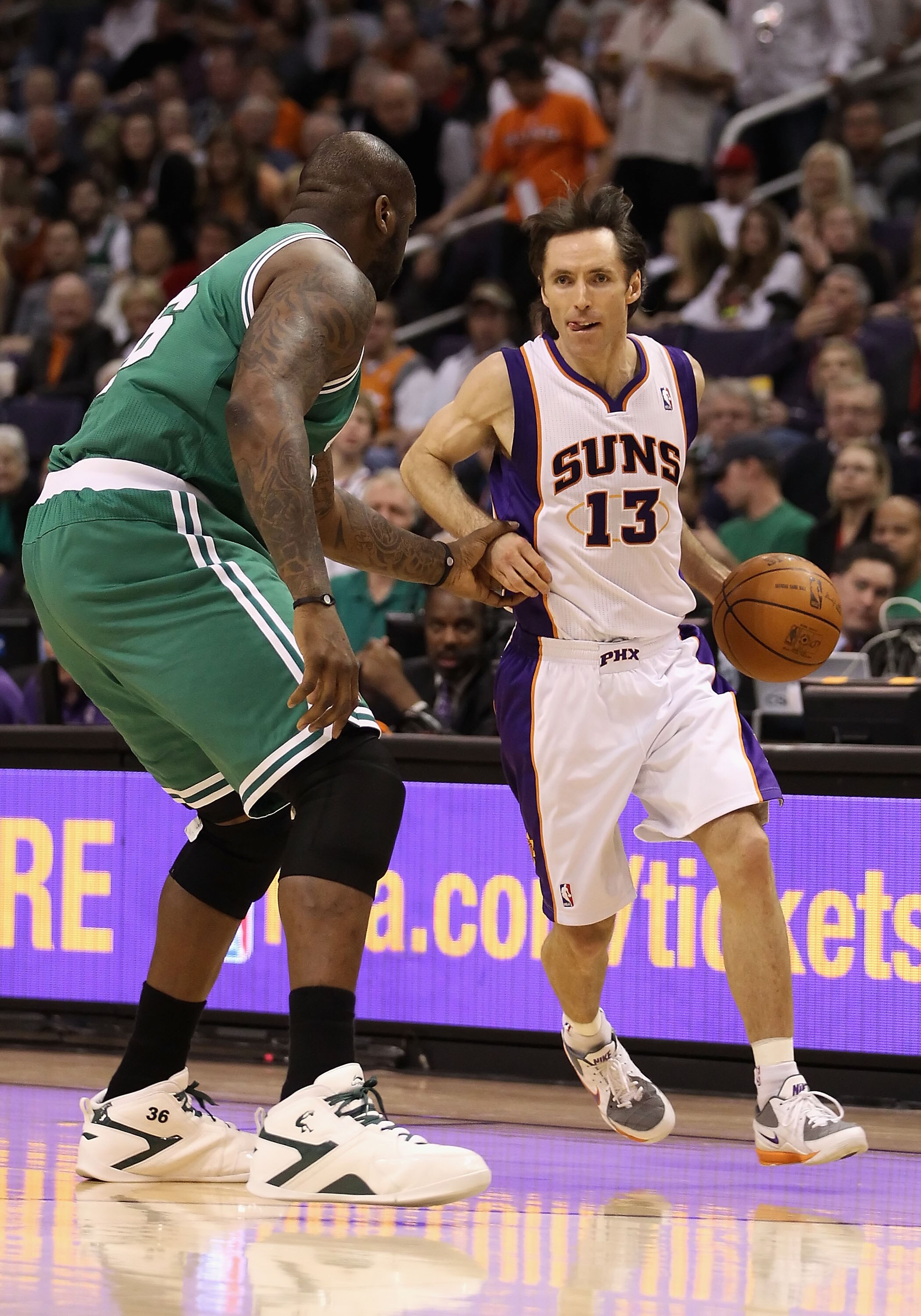 PHOENIX, AZ - JANUARY 28:  Steve Nash #13 of the Phoenix Suns handles the ball guarded by Shaquille O'Neal #36 of the Boston Celtics during the NBA game at US Airways Center on January 28, 2011 in Phoenix, Arizona. The Suns defeated the Celtics 88-71. NOT