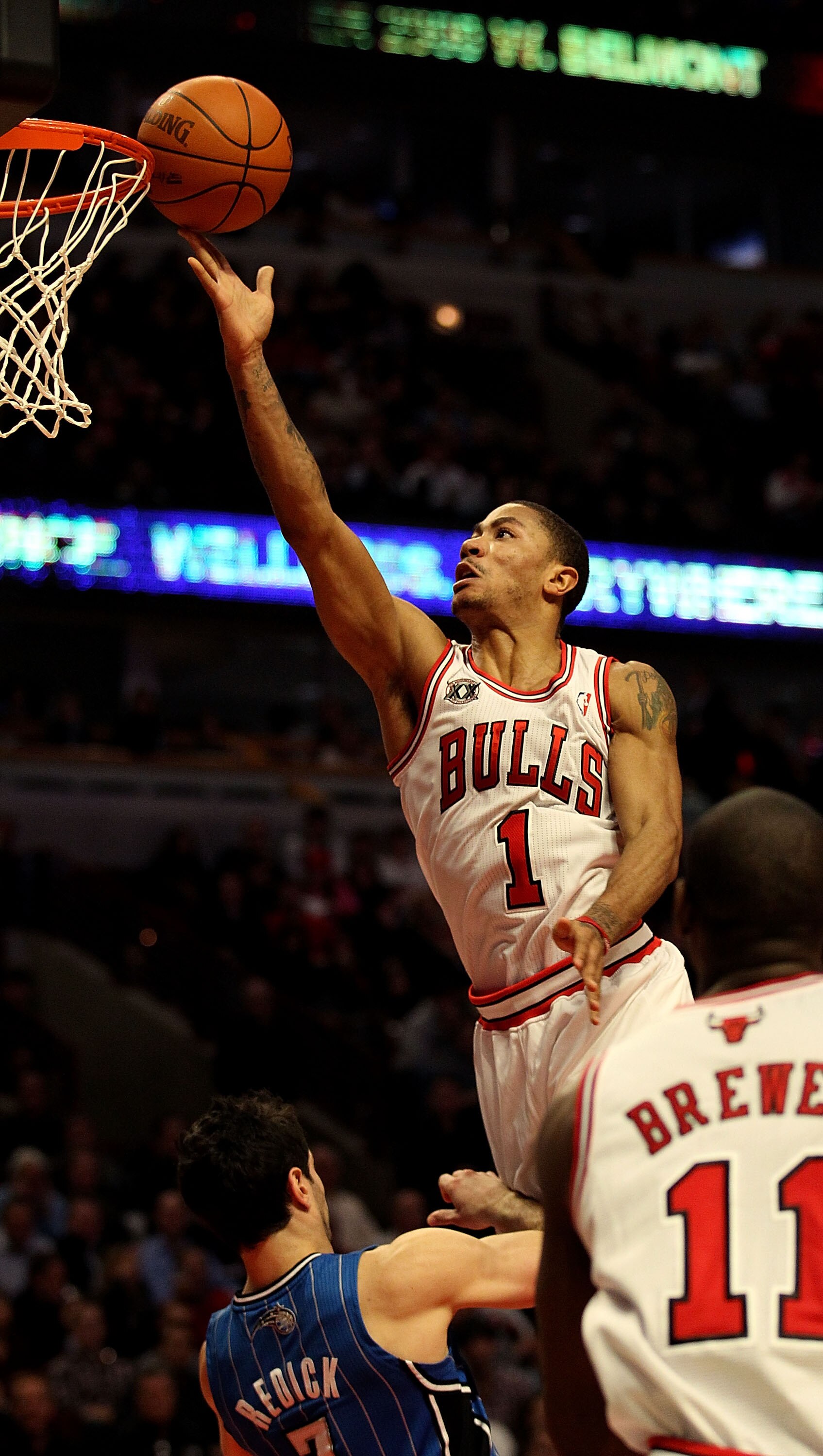 CHICAGO, IL - JANUARY 28: Derrick Rose #1 of the Chicago Bulls puts up a shot over J.J. Redick #7 of the Orlando Magic at the United Center on January 28, 2011 in Chicago, Illinois. The Bulls defeated the Magic 99-90. NOTE TO USER: User expressly acknowle