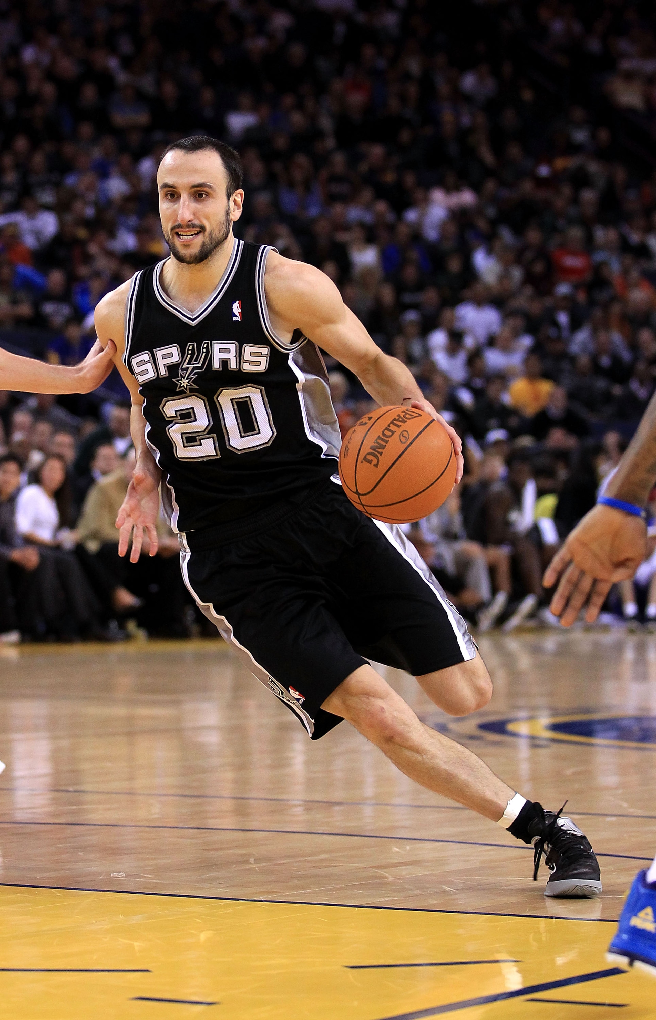 OAKLAND, CA - JANUARY 24:  Manu Ginobili #20 of the San Antonio Spurs in action against the Golden State Warriors at Oracle Arena on January 24, 2011 in Oakland, California.  NOTE TO USER: User expressly acknowledges and agrees that, by downloading and or