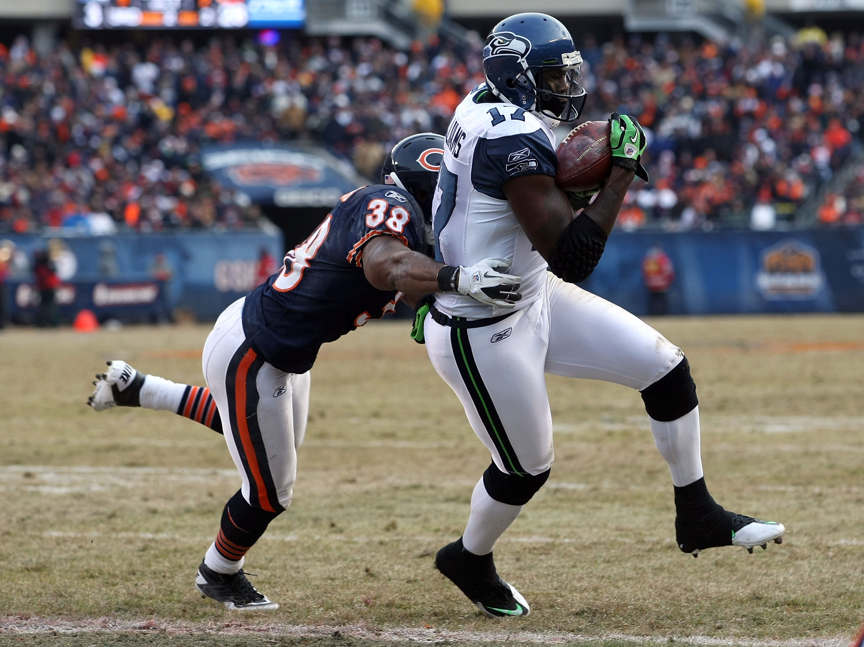 CHICAGO, IL - JANUARY 16:  Wide receiver Mike Williams #17 of the Seattle Seahawks catches a two-yard touchdown against Danieal Manning #38 of the Chicago Bears in the fourth quarter of the 2011 NFC divisional playoff game at Soldier Field on January 16,