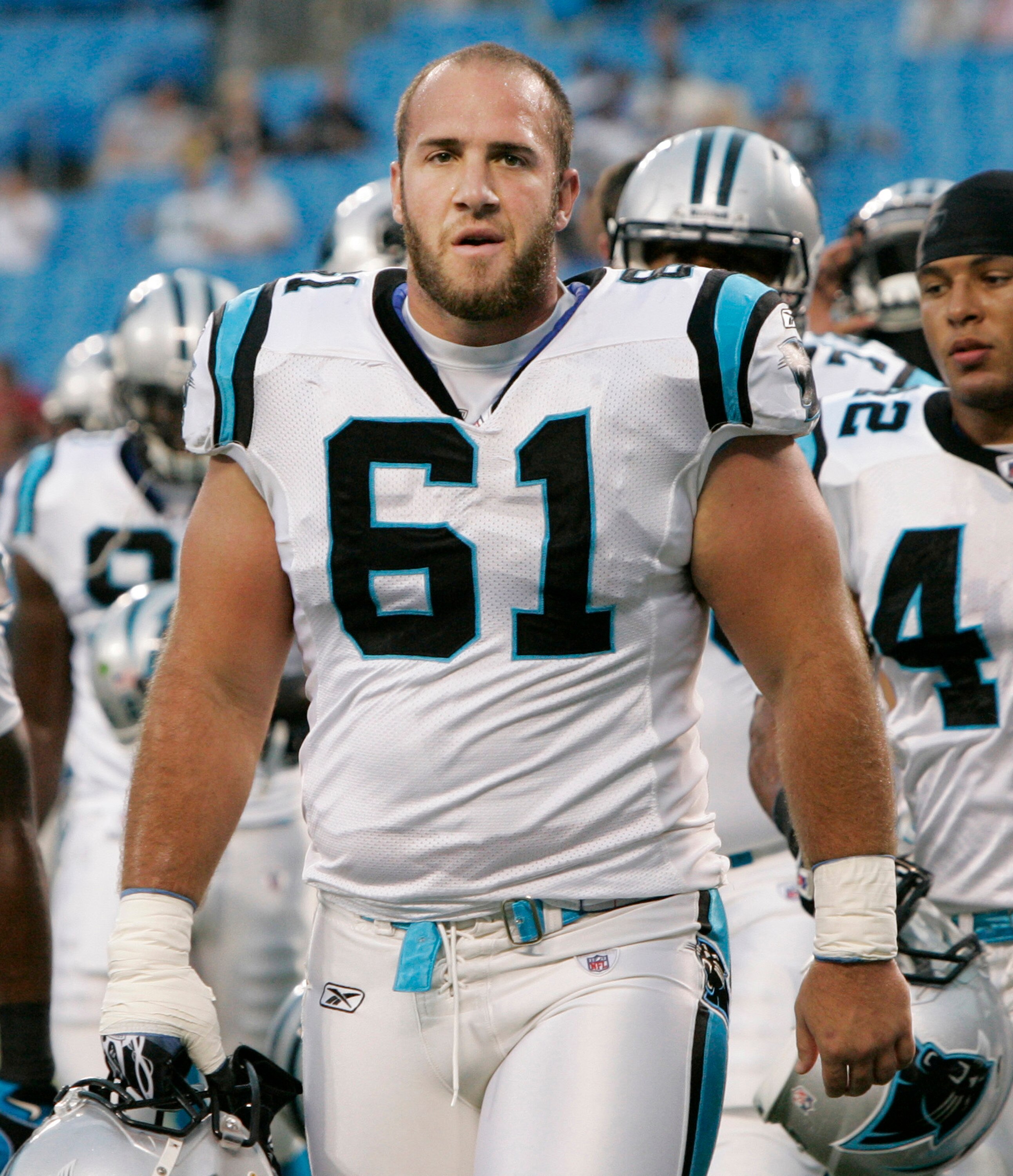 CHARLOTTE, NC - AUGUST 21:  Defensive Tackle Derek Landri #61 of the Carolina Panthers walks off the field with his team before the start of their preseason game against the New York Jets at Bank of America Stadium on August 21, 2010 in Charlotte, North C