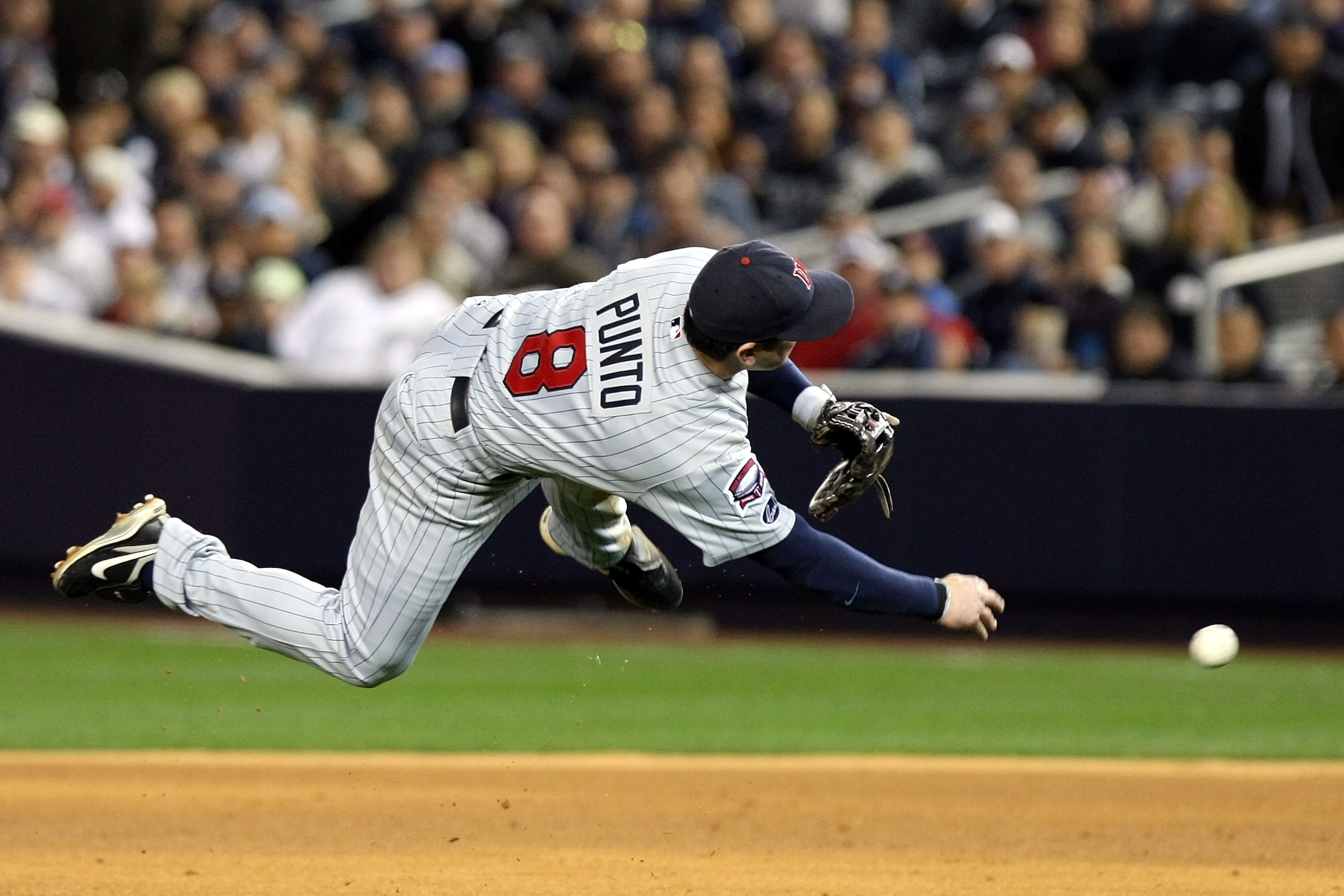 NEW YORK - OCTOBER 07:  Nick Punto #8 of the Minnesota Twins throws to first base to make an out against the New York Yankees in Game One of the ALDS during the 2009 MLB Playoffs at Yankee Stadium on October 7, 2009 in the Bronx borough of New York City.