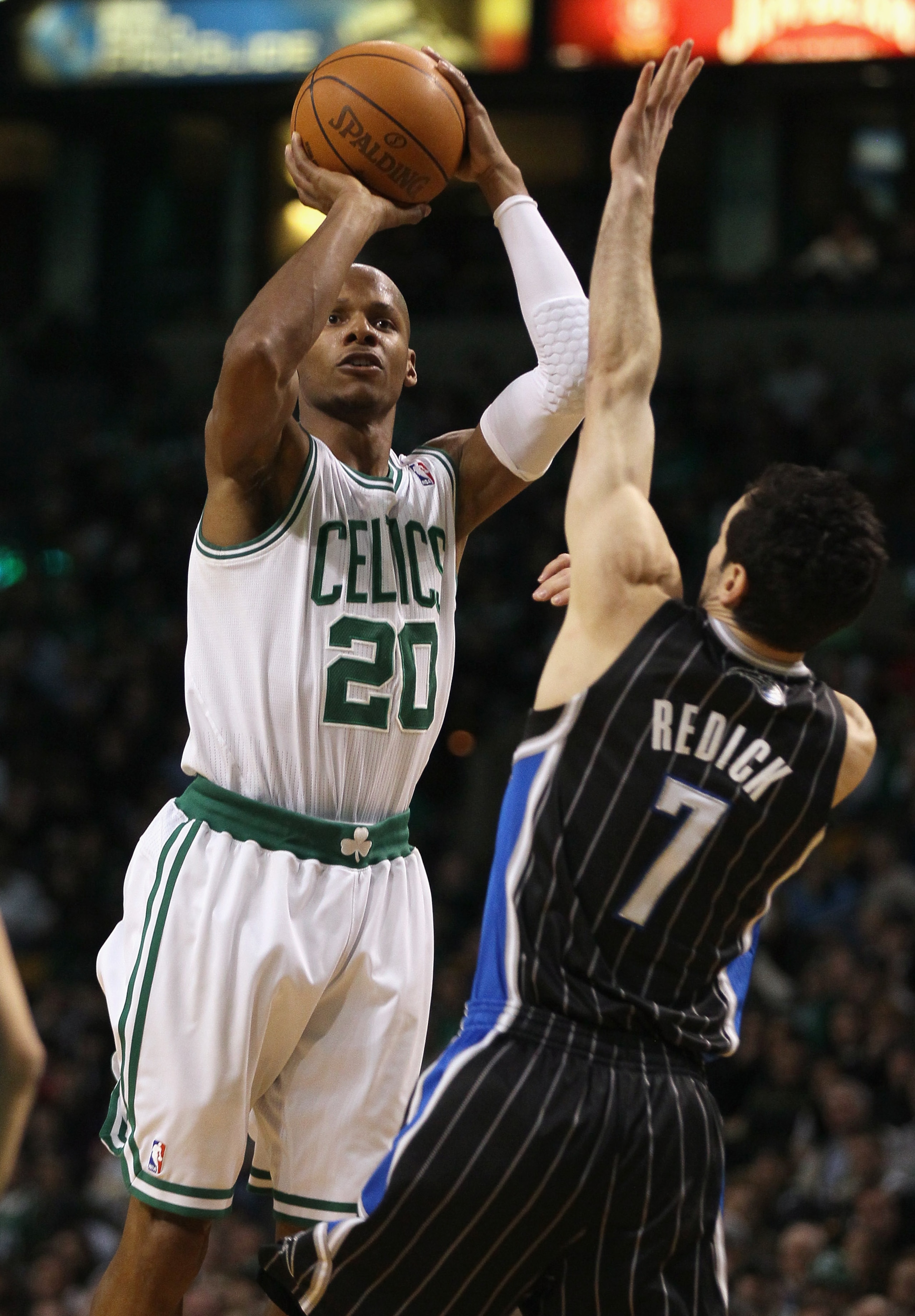 BOSTON, MA - JANUARY 17:  Ray Allen #20 of the Boston Celtics takes a shot over J.J. Redick #7 of the Orlando Magic on January 17, 2011 at the TD Garden in Boston, Massachusetts.  NOTE TO USER: User expressly acknowledges and agrees that, by downloading a