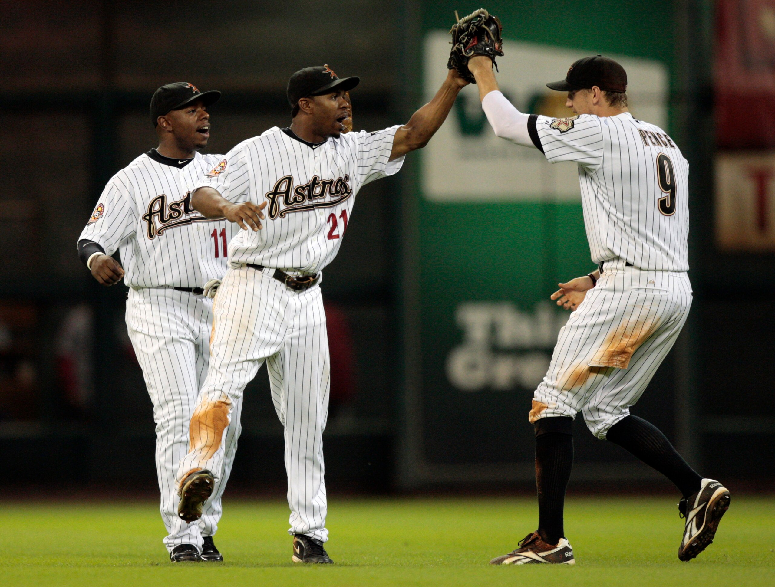 HOUSTON - AUGUST 31:  Center fielder Michael Bourn #21 and Jason Bourgeois #11 of the Houston Astros congratulate teammate Hunter Pence #9 after they defeated the St. Louis Cardinals 3-0 at Minute Maid Park on August 31, 2010 in Houston, Texas.  (Photo by