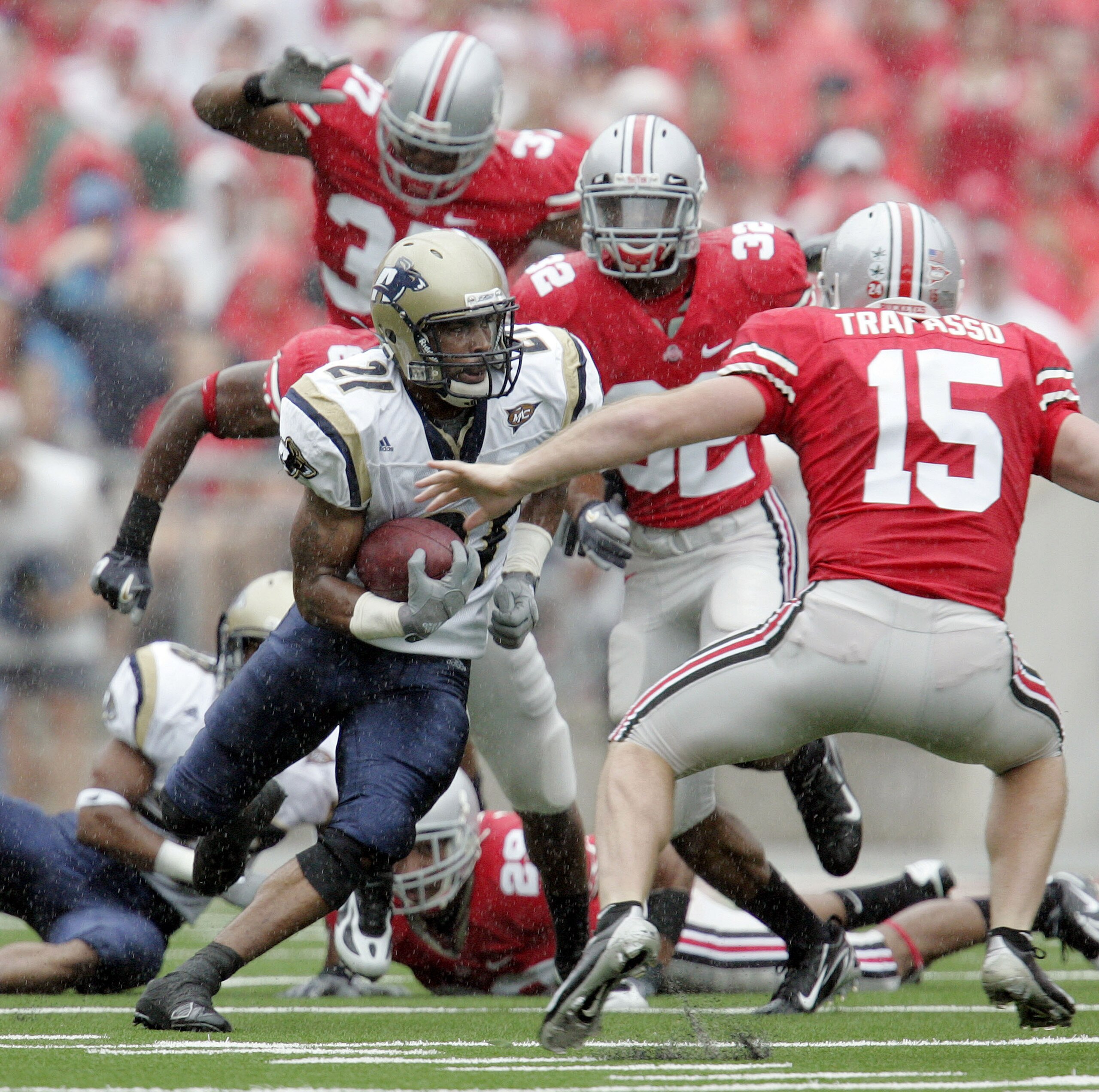 COLUMBUS - SEPTEMBER 8: Andre Jones #21 of the Akron Zips carries the ball as he is chased by Thaddeus Gibson #37, Eugene Clifford #32 and A.J. Trapasso #15 of the Ohio State Buckeyes during the first half on September 8, 2007 at Ohio Stadium in Columbus COLUMBUS - SEPTEMBER 8: Andre Jones #21 of the Akron Zips carries the ball as he is chased by Thaddeus Gibson #37, Eugene Clifford #32 and A.J. Trapasso #15 of the Ohio State Buckeyes during the first half on September 8, 2007 at Ohio Stadium in Columbus