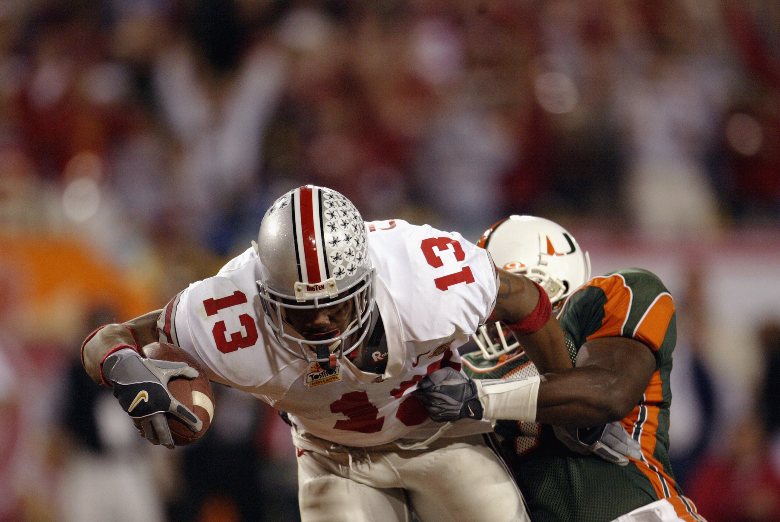 TEMPE, AZ - JANUARY 3: Running back Maurice Clarett #13 of the Ohio State Buckeyes lunges for the goaline to score the team's second touchdown against the University of Miami Hurricanes during the Tostitos Fiesta Bowl at Sun Devil Stadium on January 3, 2 TEMPE, AZ - JANUARY 3: Running back Maurice Clarett #13 of the Ohio State Buckeyes lunges for the goaline to score the team's second touchdown against the University of Miami Hurricanes during the Tostitos Fiesta Bowl at Sun Devil Stadium on January 3, 2