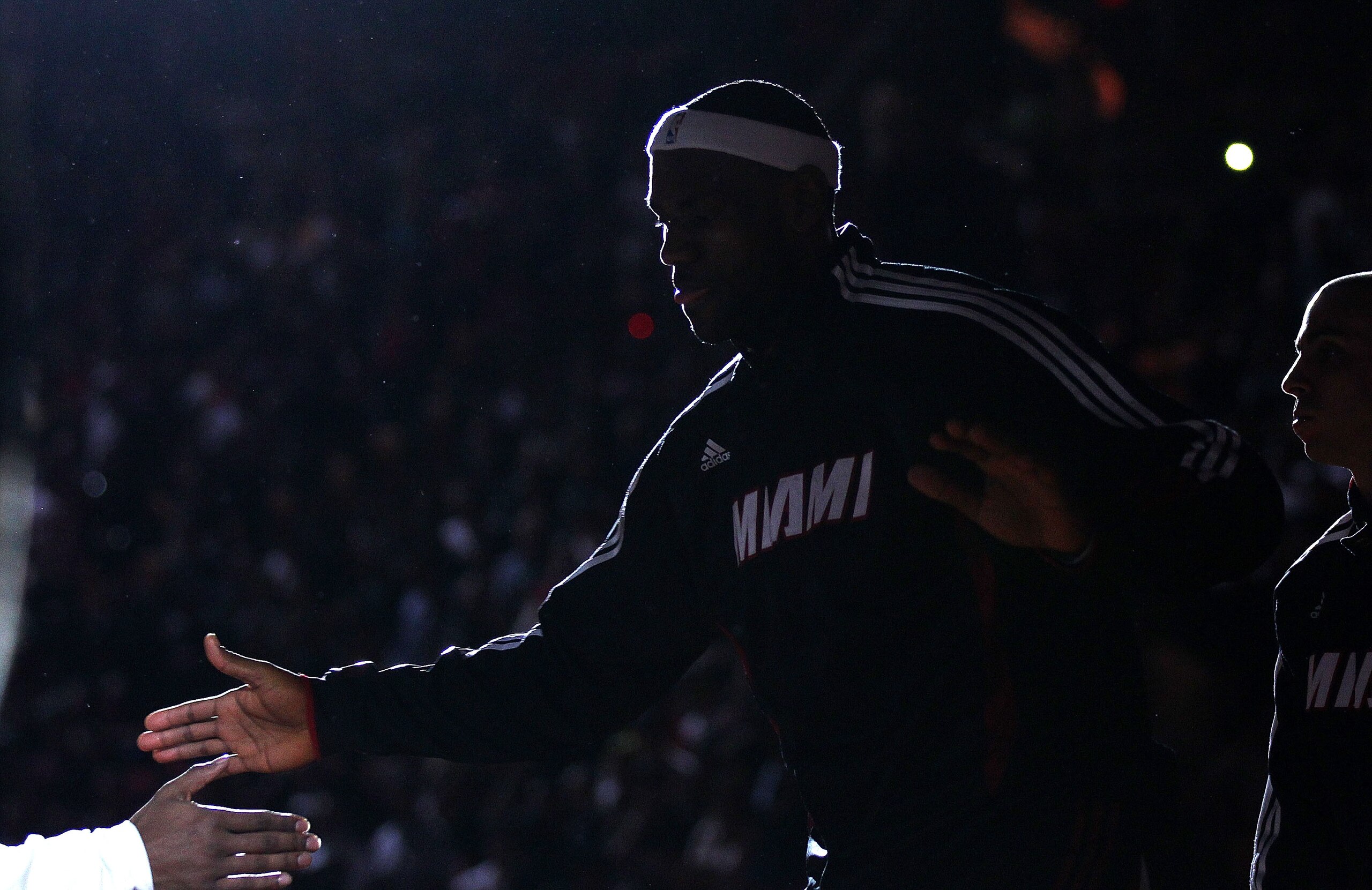 MIAMI, FL - JANUARY 22:  LeBron James #6 of the Miami Heat greets teammates during a game against the Toronto Raptors at American Airlines Arena on January 22, 2011 in Miami, Florida. NOTE TO USER: User expressly acknowledges and agrees that, by downloadi