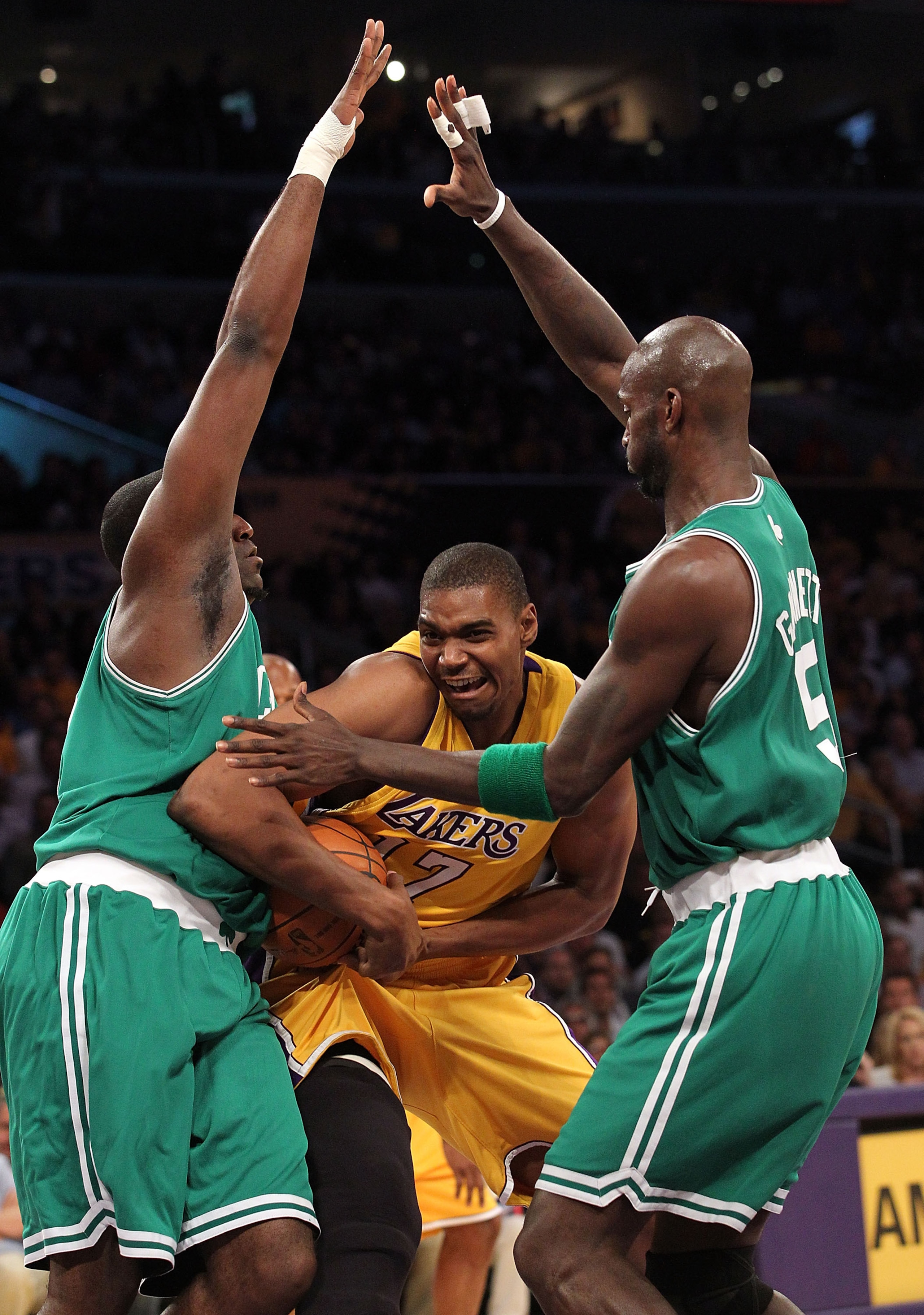 LOS ANGELES, CA - JUNE 15:  Andrew Bynum #17 of the Los Angeles Lakers drives through Kendrick Perkins #43 and Kevin Garnett #5 of the Boston Celtics in the first period of Game Six of the 2010 NBA Finals at Staples Center on June 15, 2010 in Los Angeles,