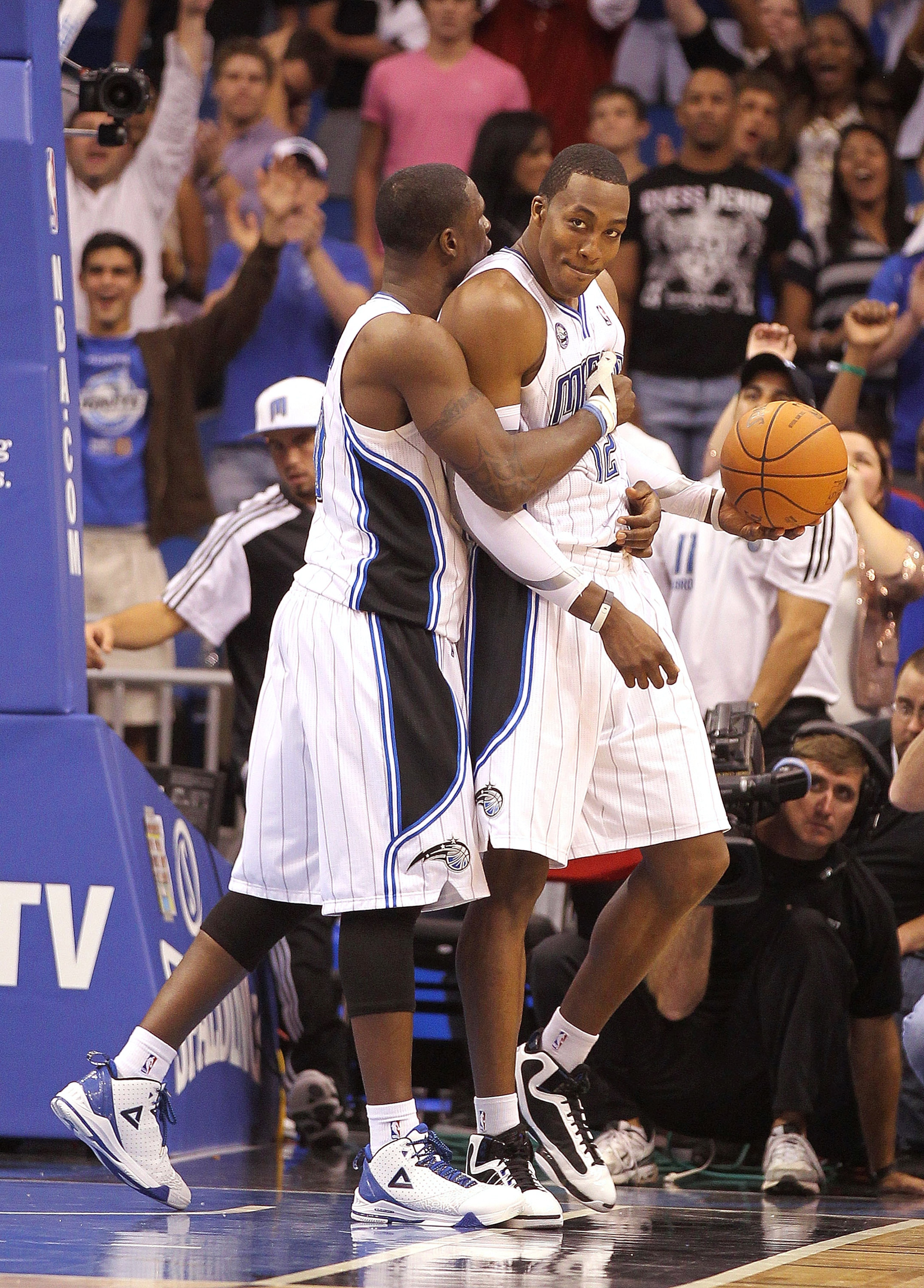 ORLANDO, FL - NOVEMBER 24:  Dwight Howard #12 of the Orlando Magic is hugged by Brandon Bass #30 after winning a game against the Miami Heat at Amway Arena on November 24, 2010 in Orlando, Florida. NOTE TO USER: User expressly acknowledges and agrees that