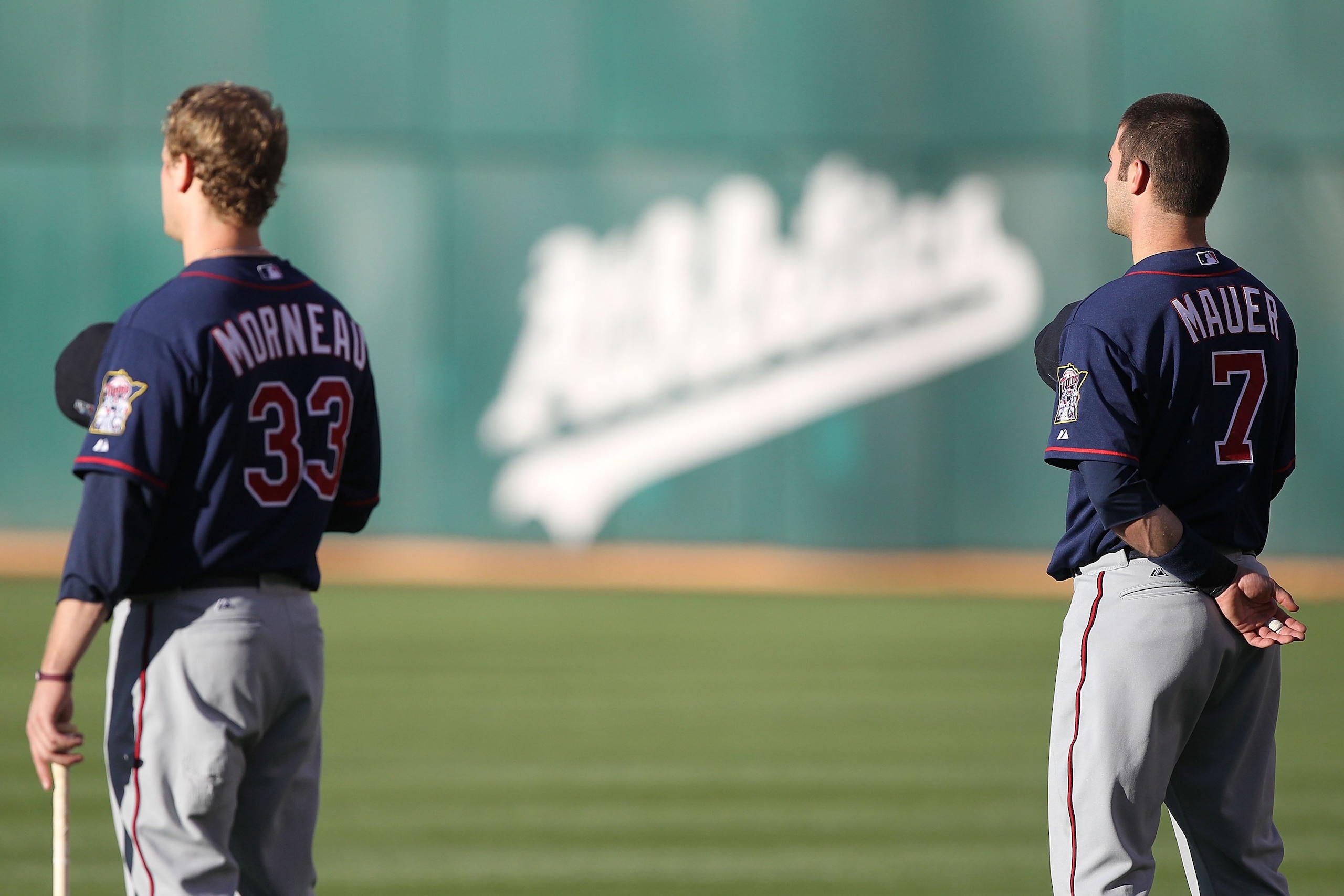 OAKLAND, CA - JUNE 04:  Justin Morneau #33 and Joe Mauer #7 of the Minnesota Twins look on against the Oakland Athletics during an MLB game at the Oakland-Alameda County Coliseum on June 4, 2010 in Oakland, California.  (Photo by Jed Jacobsohn/Getty Image