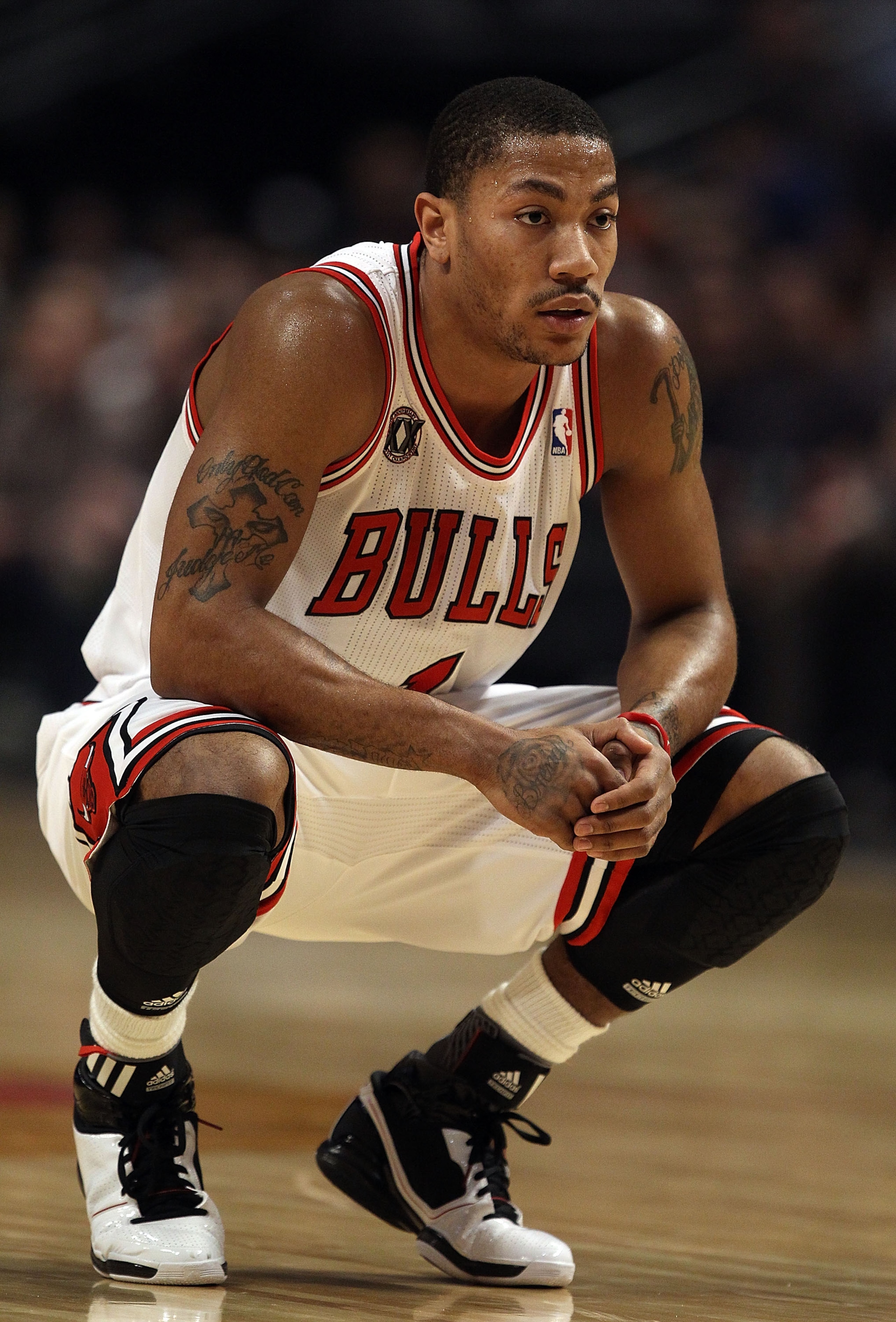 CHICAGO, IL - JANUARY 28: Derrick Rose #1 of the Chicago Bulls rests as a member of the Orlando Magic shoots a free-throw at the United Center on January 28, 2011 in Chicago, Illinois. NOTE TO USER: User expressly acknowledges and agrees that, by download