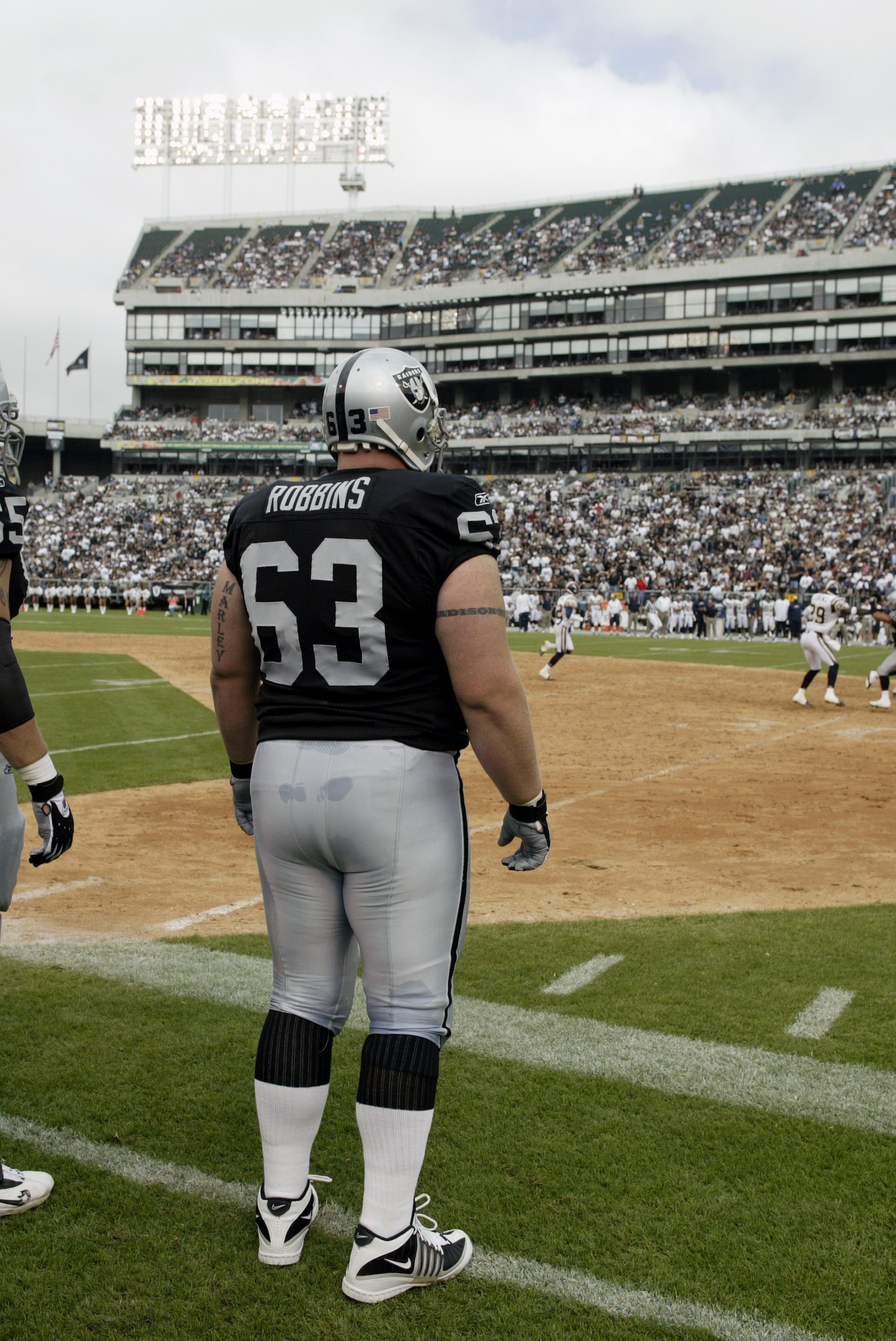 OAKLAND, CA  - SEPTEMBER 28:  Center Barret Robbins #63 of the Oakland Raiders waits to play against the San Diego Chargers on September 28, 2003 at Network Associates Coliseum in Oakland, California. The Raiders defeated the Chargers 34-31 in overtime. (