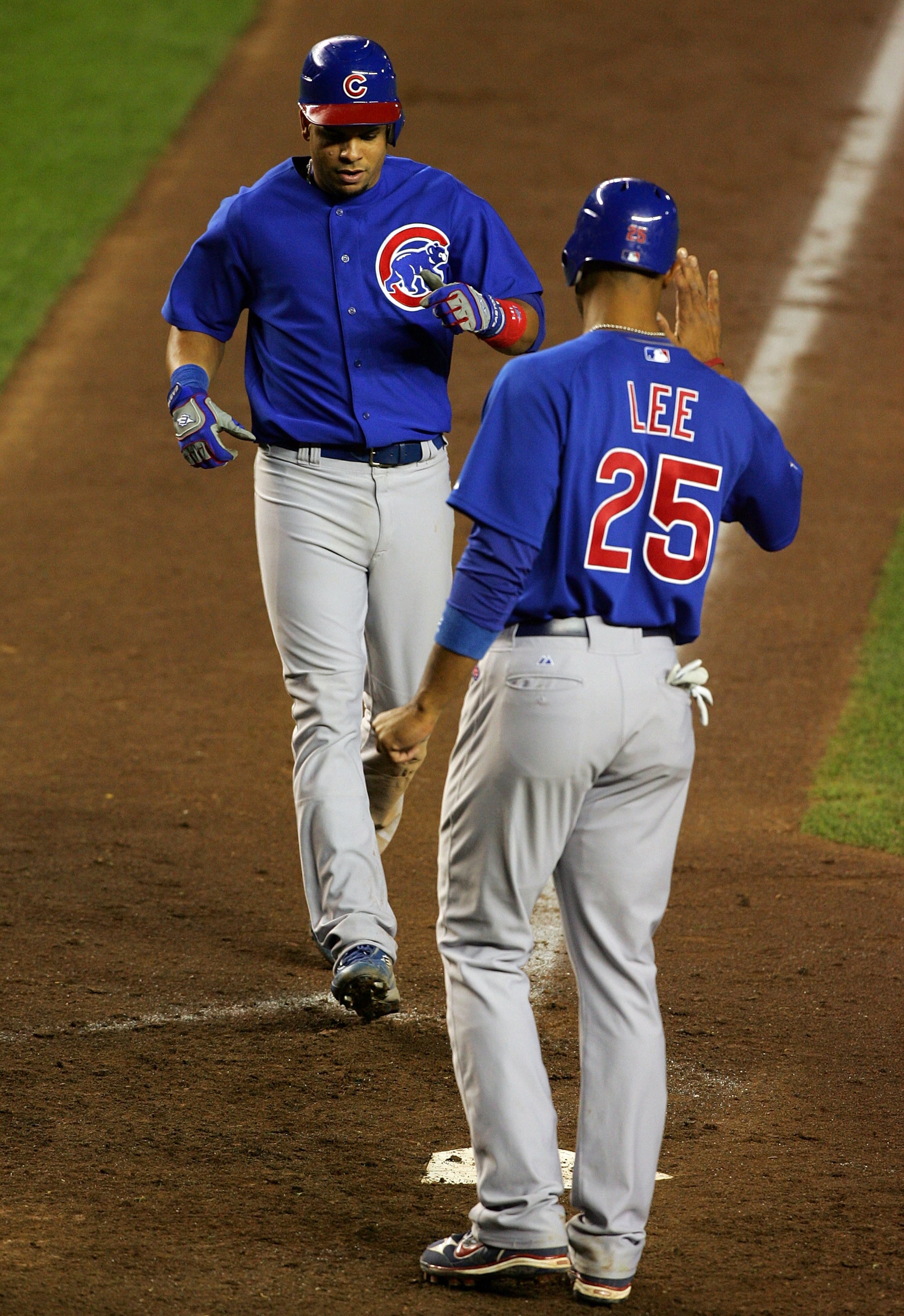 NEW YORK - SEPTEMBER 24:  Derrek Lee #25 of the Chicago Cubs greets teammate Aramis Ramirez #16 at home after Ramirez hit a two-run home run in the tenth inning against the New York Mets at Shea Stadium September 24, 2008 in the Flushing neighborhood of t