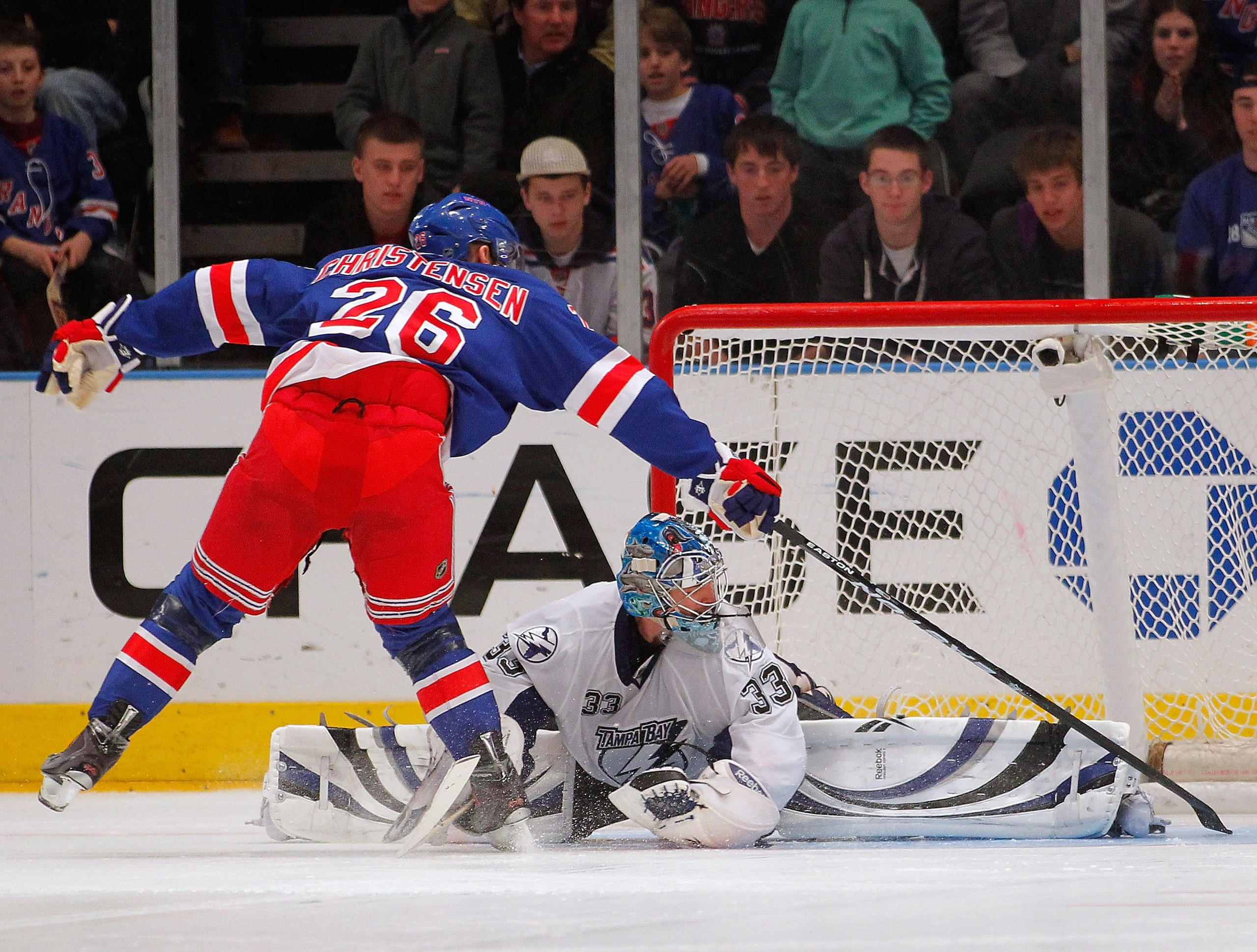 NEW YORK, NY - DECEMBER 23:  Erik Christensen #26 of the New York Rangers wraps the puck around Goalie Dan Ellis #33 of the Tampa Bay Lightning to score the first goal of the shootout of an NHL hockey game at Madison Square Garden on December 23, 2010 in