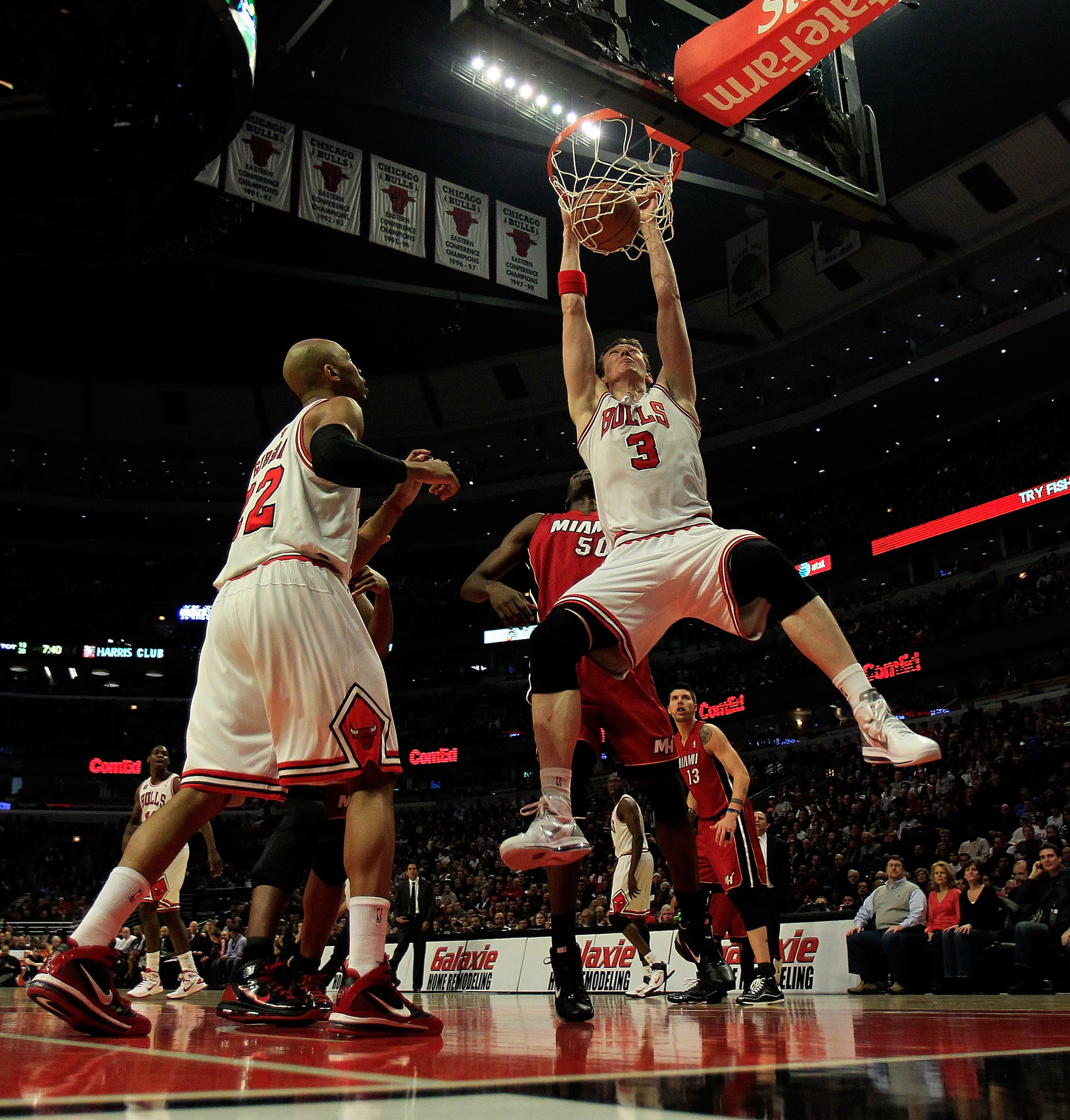 CHICAGO, IL - JANUARY 15: Omer Asik #3 of the Chicago Bulls dunks the ball against the Miami Heat as teammate Taj Gibson #22 watches at the United Center on December 28, 2011 in Chicago, Illinois. The Bulls defeated the Heat 99-96. NOTE TO USER: User expr