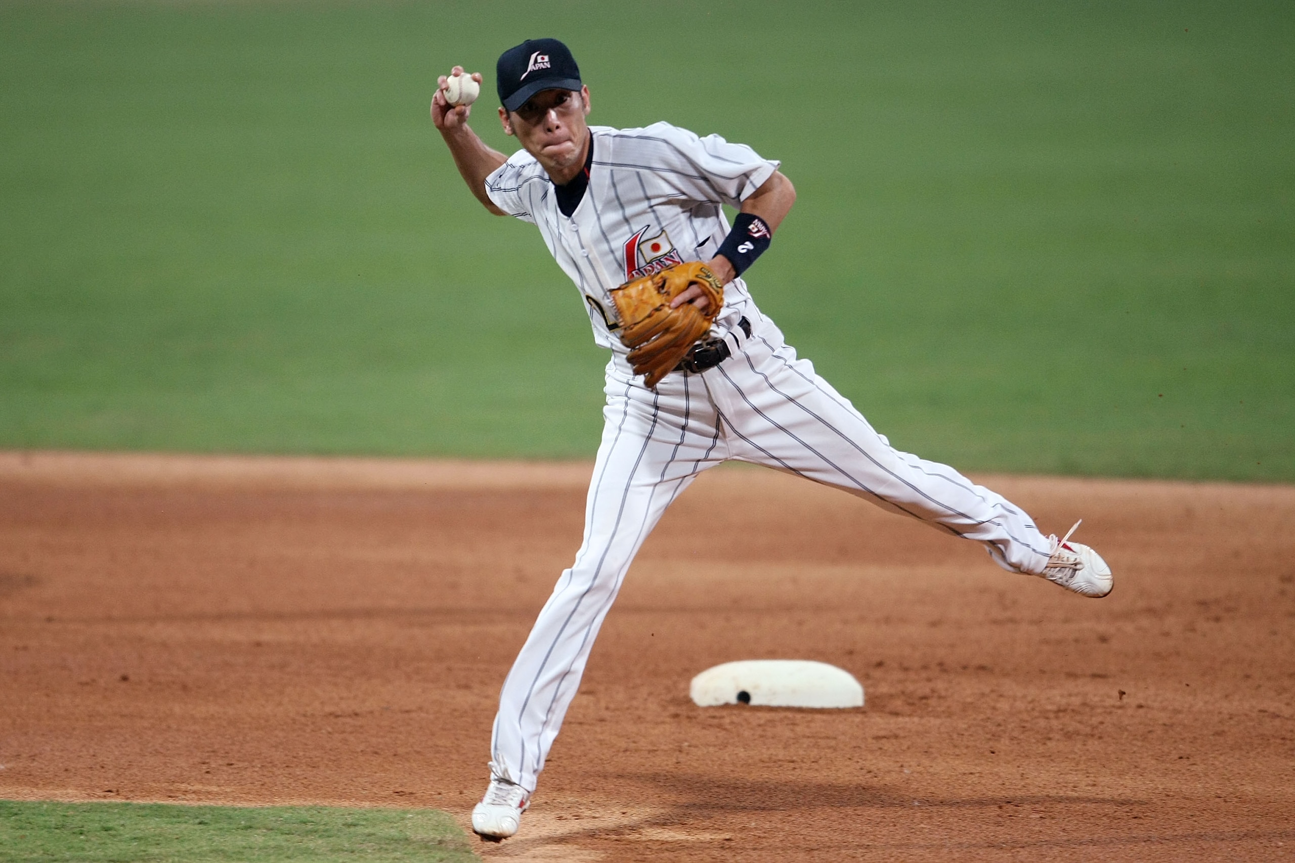 BEIJING - AUGUST 20:  Tsuyoshi Nishioka of Japan throws onto first for the putout against the United States in the baseball event at the Wukesong Baseball Field during Day 12 of the Beijing 2008 Olympic Games on August 20, 2008 in Beijing, China.  (Photo