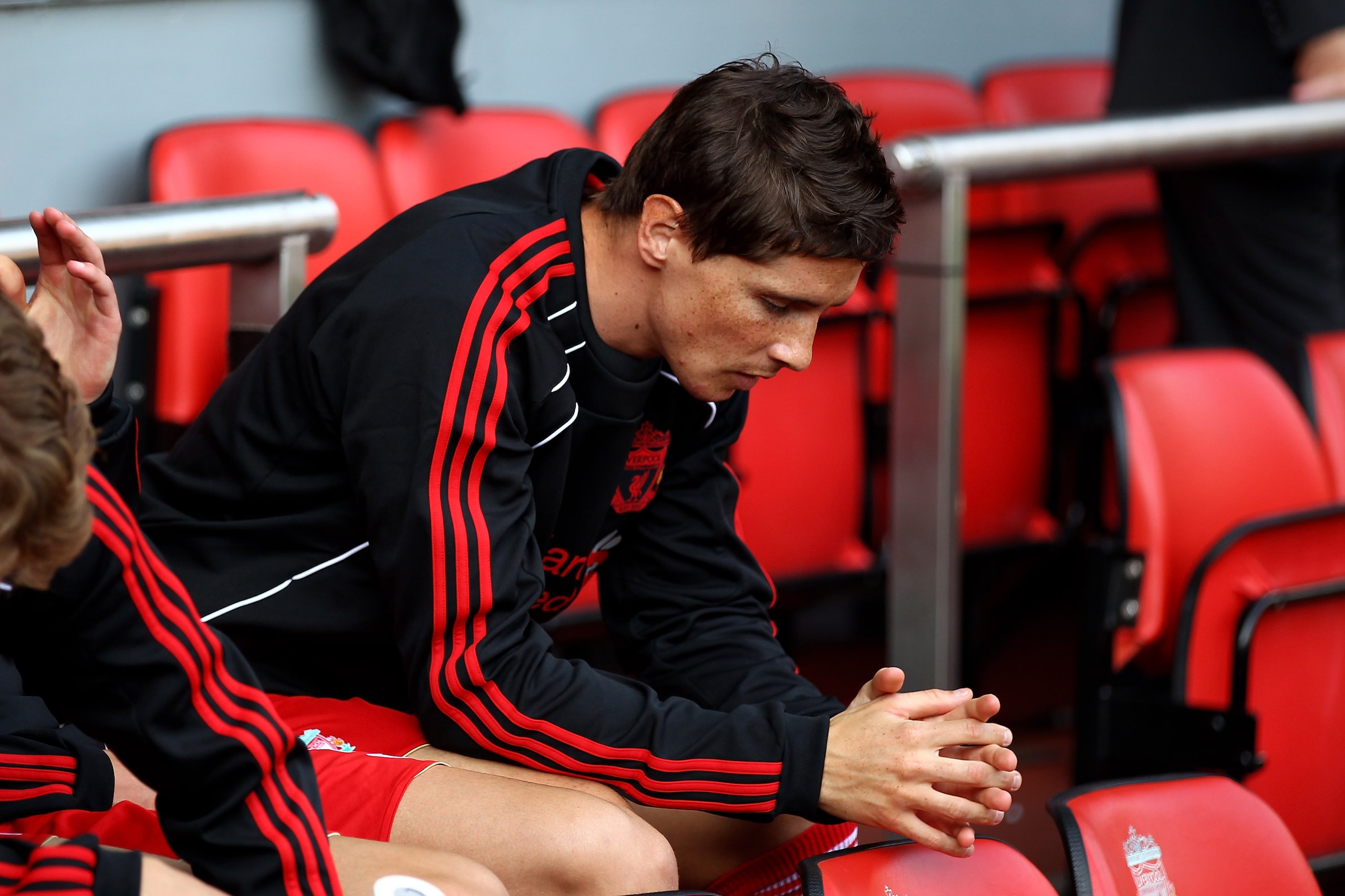 LIVERPOOL, ENGLAND - AUGUST 15: Fernando Torres of Liverpool sits on the bench as a substitute during the Barclays Premier League match between Liverpool and Arsenal at Anfield on August 15, 2010 in Liverpool, England. (Photo by Clive Brunskill/Getty Im LIVERPOOL, ENGLAND - AUGUST 15: Fernando Torres of Liverpool sits on the bench as a substitute during the Barclays Premier League match between Liverpool and Arsenal at Anfield on August 15, 2010 in Liverpool, England. (Photo by Clive Brunskill/Getty Im