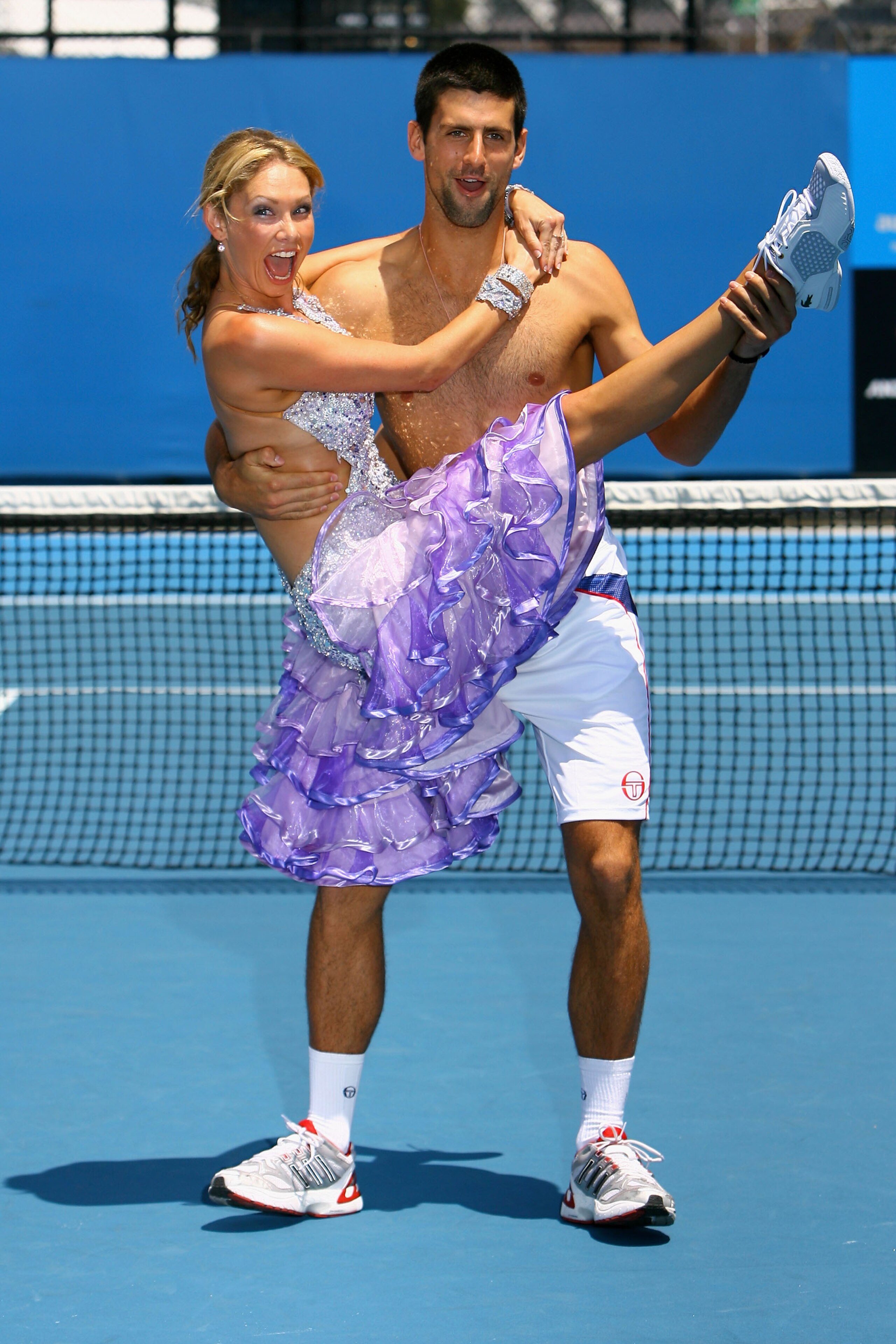MELBOURNE, AUSTRALIA - JANUARY 21: Novak Djokovic of Serbia and 'Dancing With the Stars' dancer Kym Johnson perform a routine during day five of the 2011 Australian Open at Melbourne Park on January 21, 2011 in Melbourne, Australia. (Photo by Robert Prezi