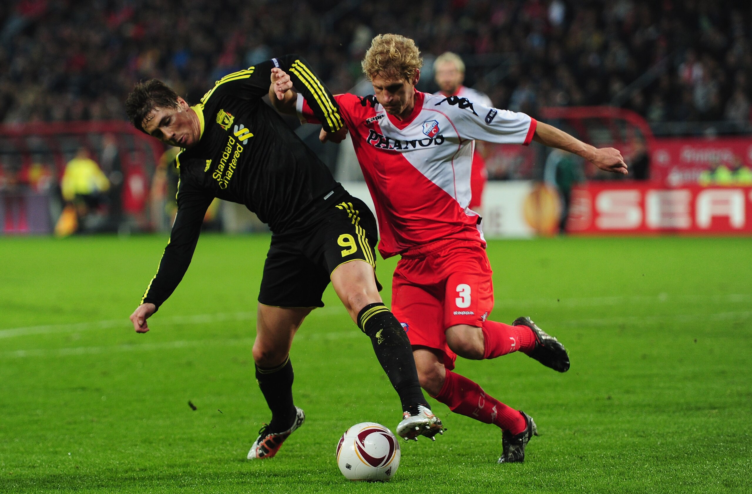UTRECHT, NETHERLANDS - SEPTEMBER 30: Fernando Torres of Liverpool battles with Mircea Nesu of FC Utrecht during the UEFA Europa League match between FC Utrecht and Liverpool at the Stadion Galgenwaard on September 30, 2010 in Utrecht, Netherlands. (Phot UTRECHT, NETHERLANDS - SEPTEMBER 30: Fernando Torres of Liverpool battles with Mircea Nesu of FC Utrecht during the UEFA Europa League match between FC Utrecht and Liverpool at the Stadion Galgenwaard on September 30, 2010 in Utrecht, Netherlands. (Phot