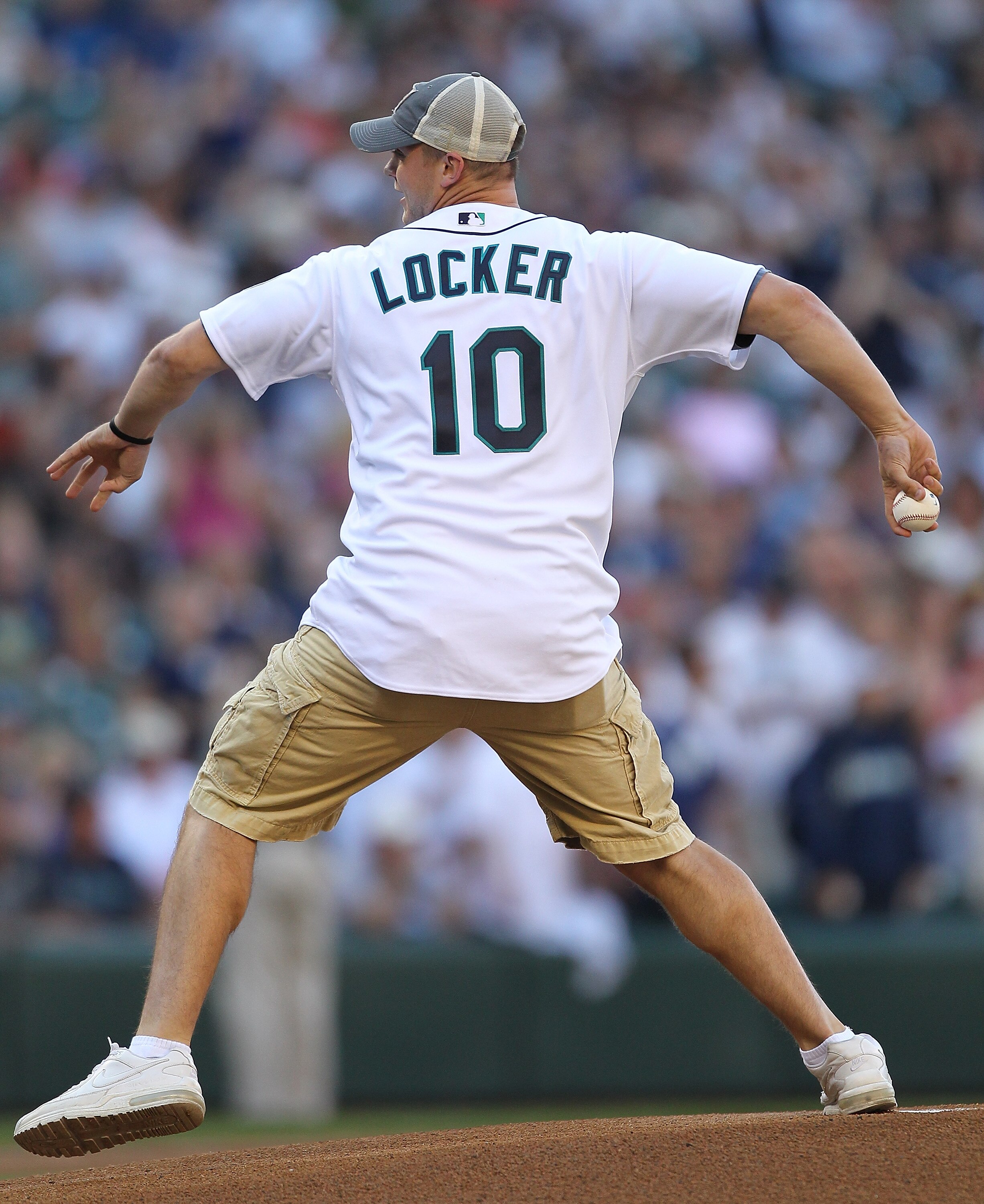 SEATTLE - JULY 10:  Quarterback Jake Locker of the University of Washington Huskies throws out the ceremonial first pitch prior to the game between the Seattle Mariners and the New York Yankees at Safeco Field on July 10, 2010 in Seattle, Washington. (Pho