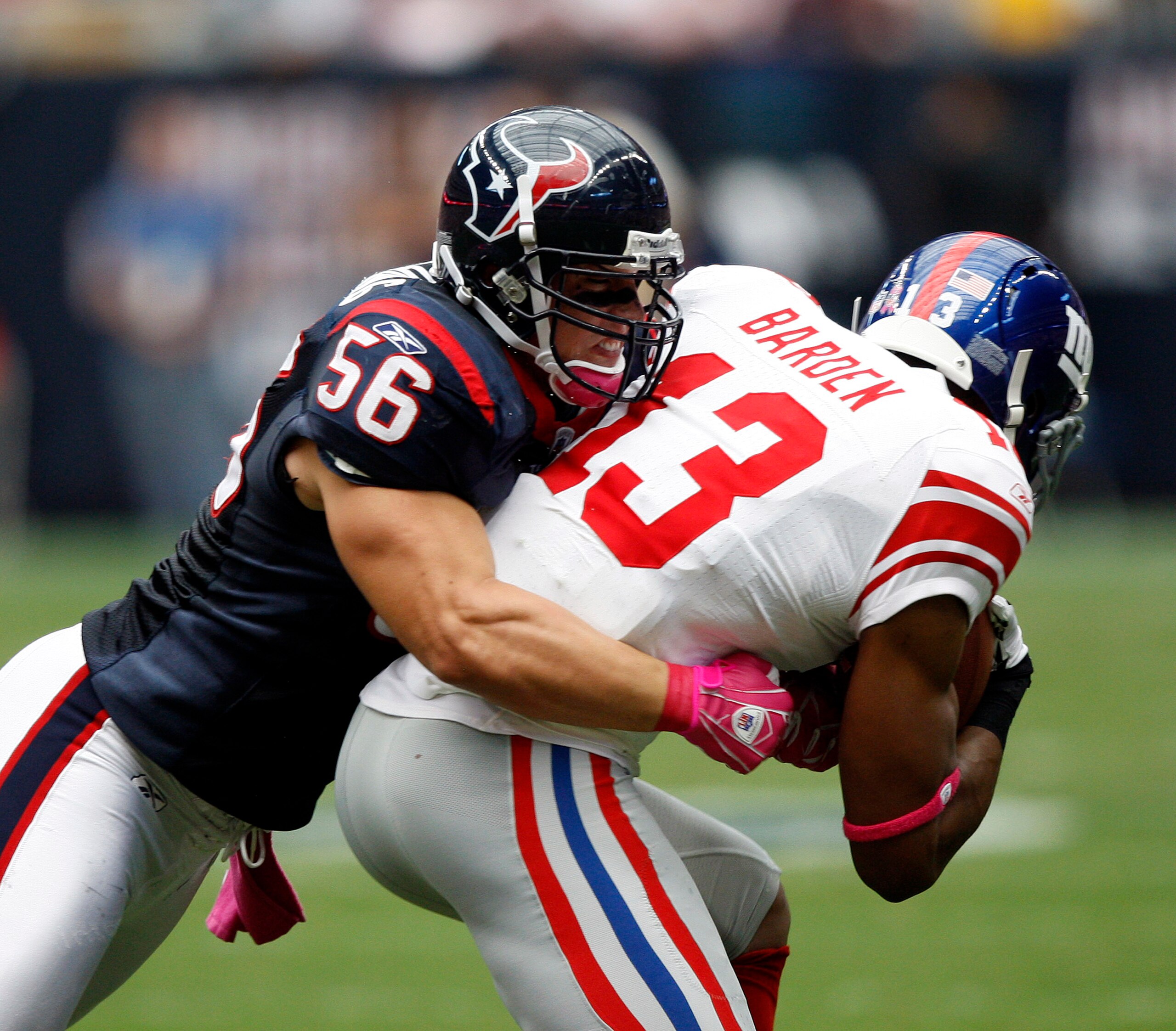 HOUSTON - OCTOBER 10:  Wide receiver Ramses Barden #13 of the New York Giants is wrapped up by linebacker Brian Cushing #56 of the Houston Texans at Reliant Stadium on October 10, 2010 in Houston, Texas.  (Photo by Bob Levey/Getty Images)