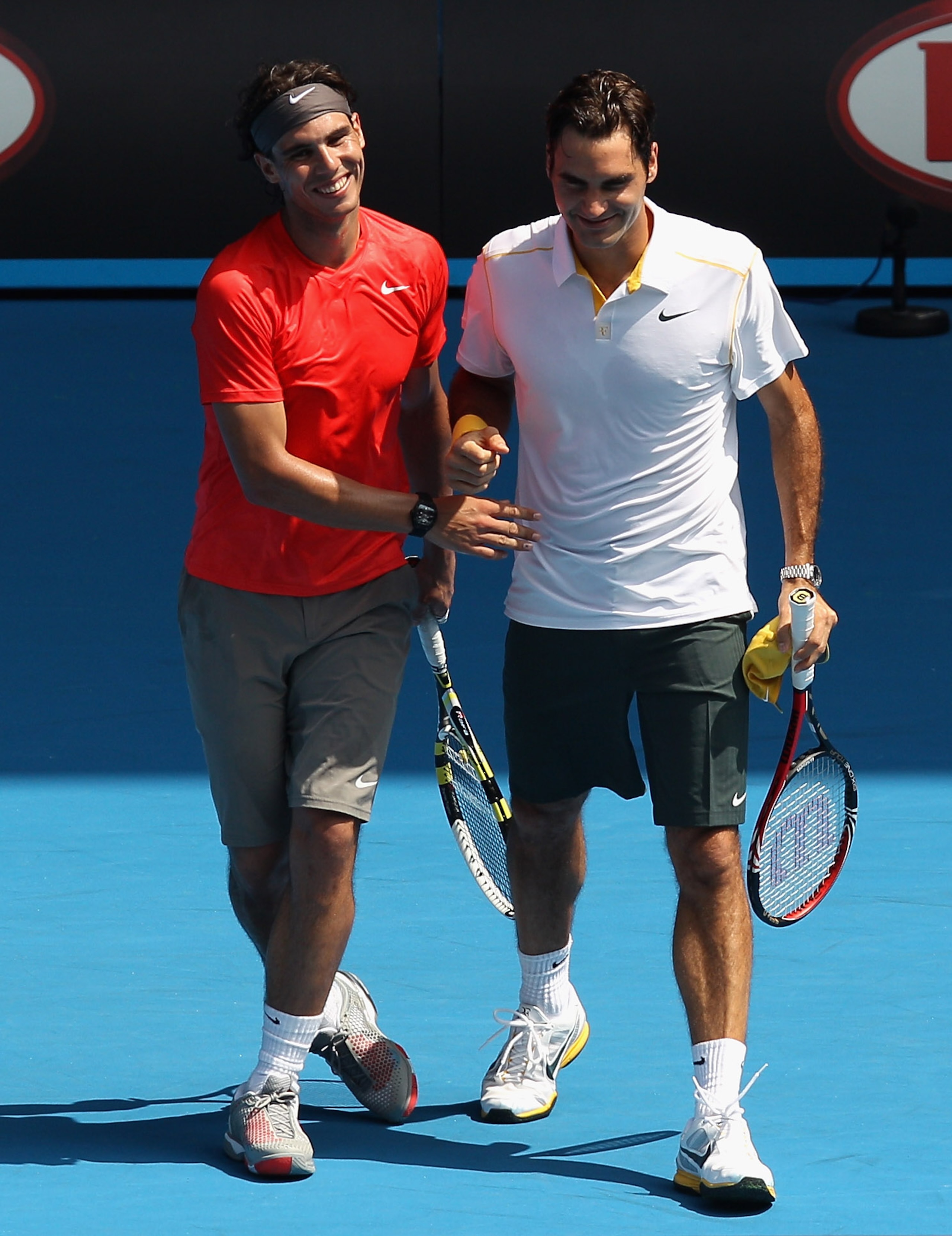 MELBOURNE, AUSTRALIA - JANUARY 16:  Rafael Nadal of Spain and Roger Federer of Switzerland celebrate a point during the 'Rally For Relief' charity exhibition match ahead of the 2011 Australian Open at Melbourne Park on January 16, 2011 in Melbourne, Austr