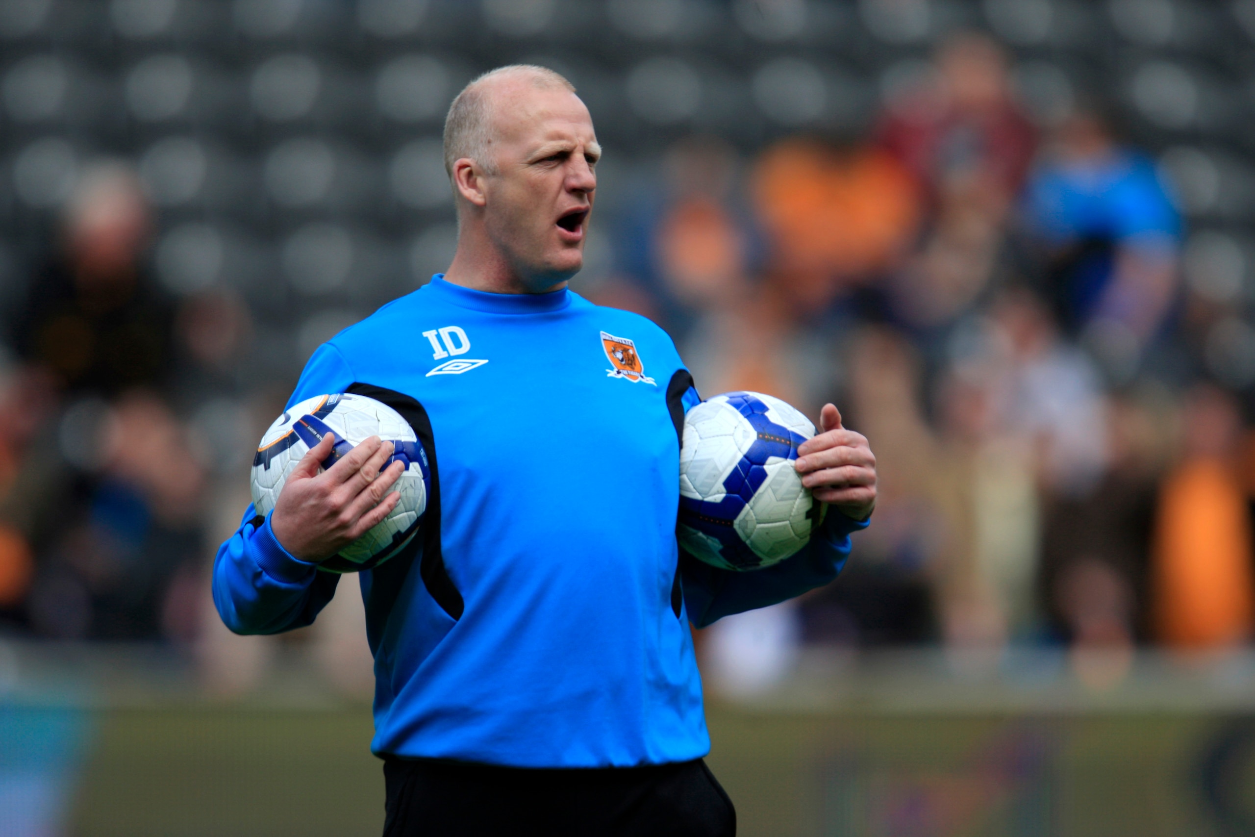 HULL, ENGLAND - MAY 9: Hull City interim manager Iain Dowie shouts instructions as he holds two footballs during the Barclays Premier League match between Hull City and Liverpool at the KC Stadium on May 9, 2010 in Hull, England. (Photo by Jed Leicester/G