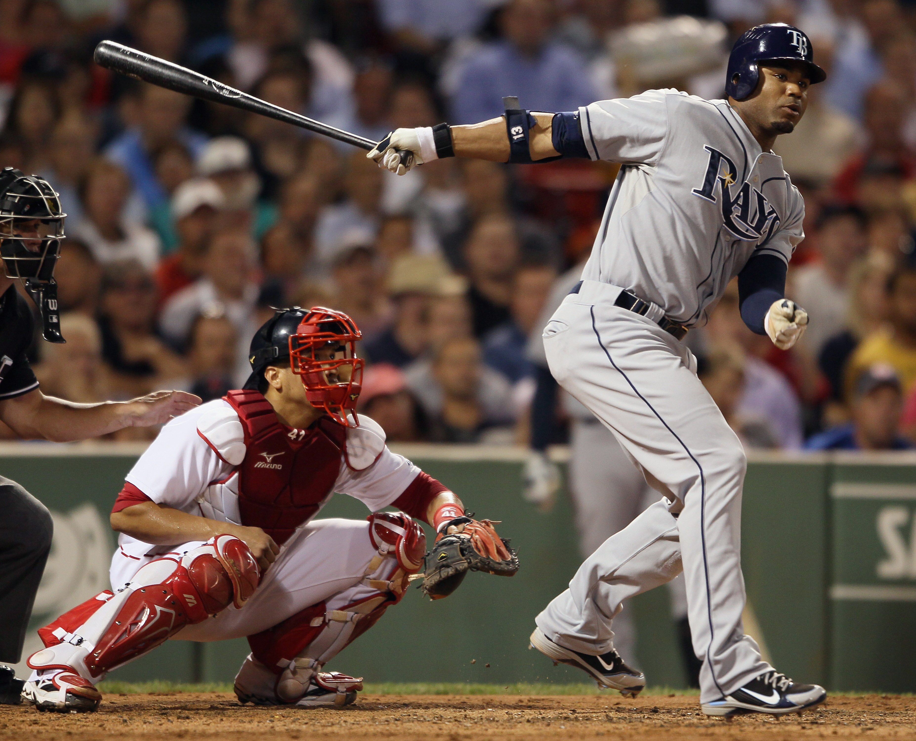 BOSTON - SEPTEMBER 07:  Carl Crawford #13 of the Tampa Bay Rays hits a 2 RBI double in the fourth inning as Victor Martinez #41 of the Boston Red Sox catches on September 7, 2010 at Fenway Park in Boston, Massachusetts.  (Photo by Elsa/Getty Images)