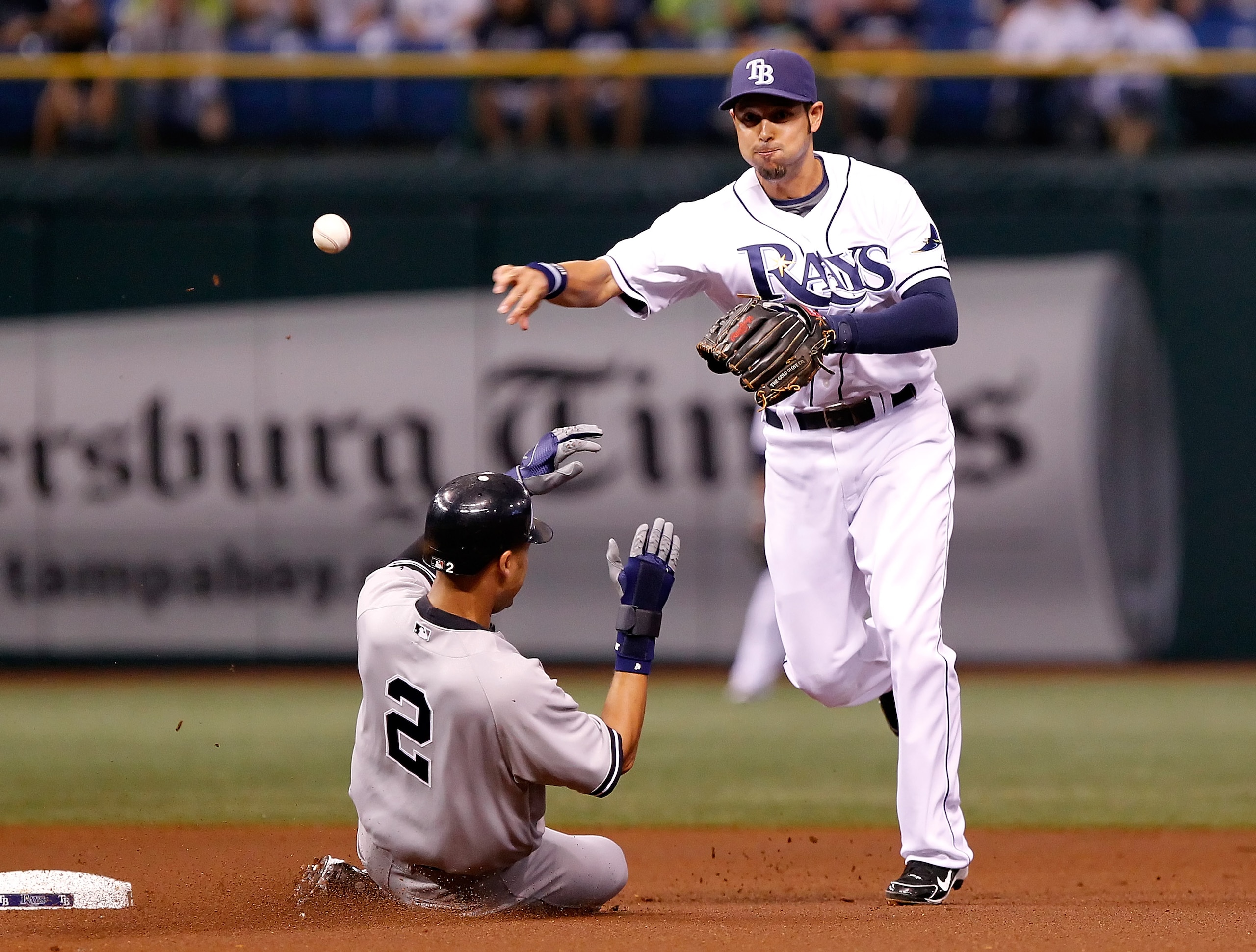 ST. PETERSBURG - SEPTEMBER 13:  Shortstop Jason Bartlett #8 of the Tampa Bay Rays turns a double play as Derek Jeter #2 of the New York Yankees tries to break it up during the game at Tropicana Field on September 13, 2010 in St. Petersburg, Florida.  (Pho