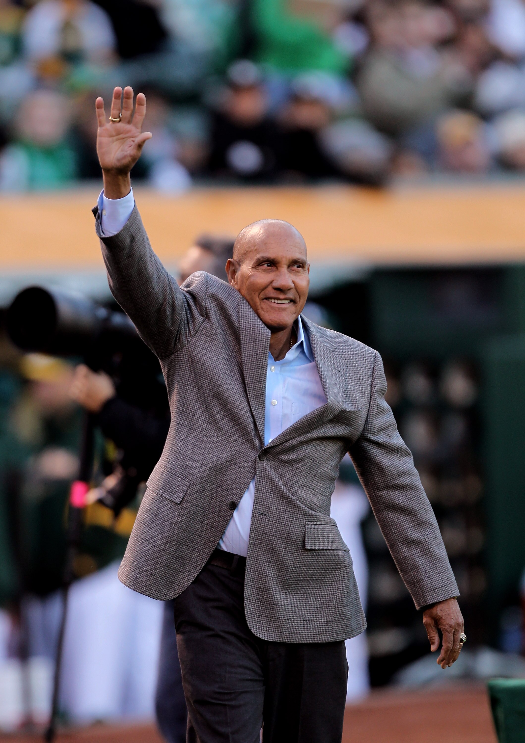 OAKLAND, CA - APRIL 05:  Former Athletics' player Bert Campaneris waves to the crowd before being honored in a ceremony before the game between the Seattle Mariners and the Oakland Athletics on Opening Day at the Oakland-Alameda County Coliseum on April 5