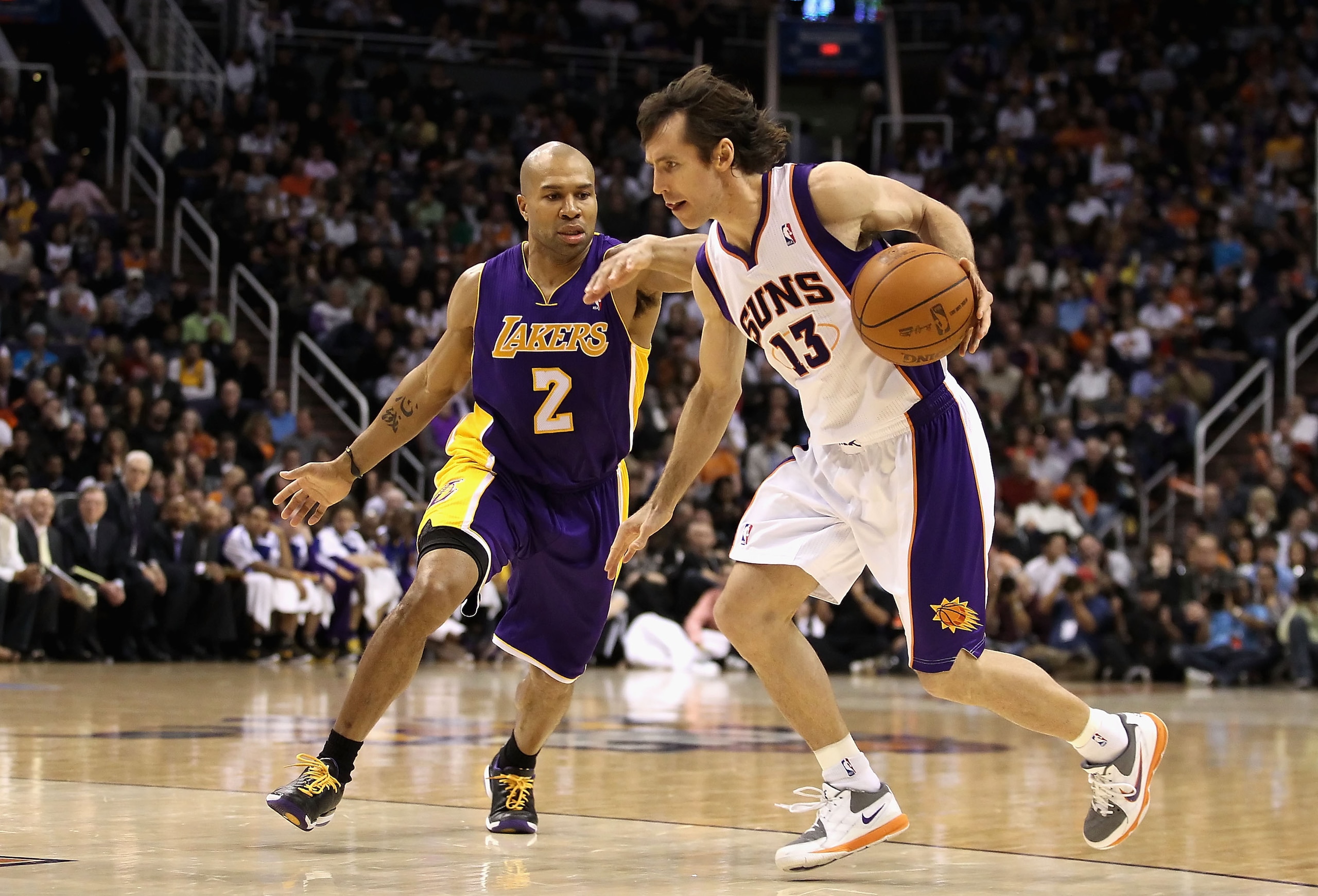 PHOENIX, AZ - JANUARY 05: Steve Nash #13 of the Phoenix Suns hanldes the ball under pressure from Derek Fisher #2 of the Los Angeles Lakers during the NBA game at US Airways Center on January 5, 2011 in Phoenix, Arizona. The Lakers defeated the Suns 99-9 PHOENIX, AZ - JANUARY 05: Steve Nash #13 of the Phoenix Suns hanldes the ball under pressure from Derek Fisher #2 of the Los Angeles Lakers during the NBA game at US Airways Center on January 5, 2011 in Phoenix, Arizona. The Lakers defeated the Suns 99-9