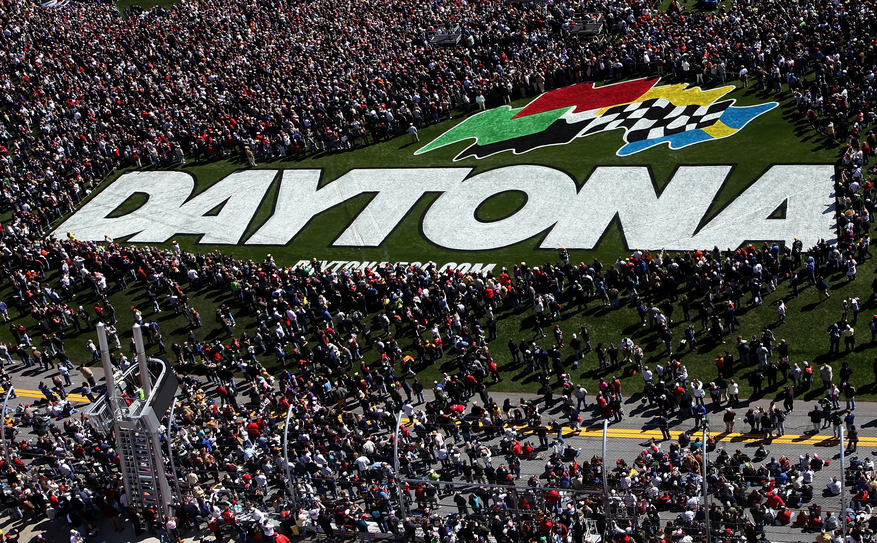 DAYTONA BEACH, FL - FEBRUARY 14:  Fans crowd the infield trioval grass during pre-race festivities before  the NASCAR Sprint Cup Series Daytona 500 at Daytona International Speedway on February 14, 2010 in Daytona Beach, Florida.  (Photo by Jonathan Ferre