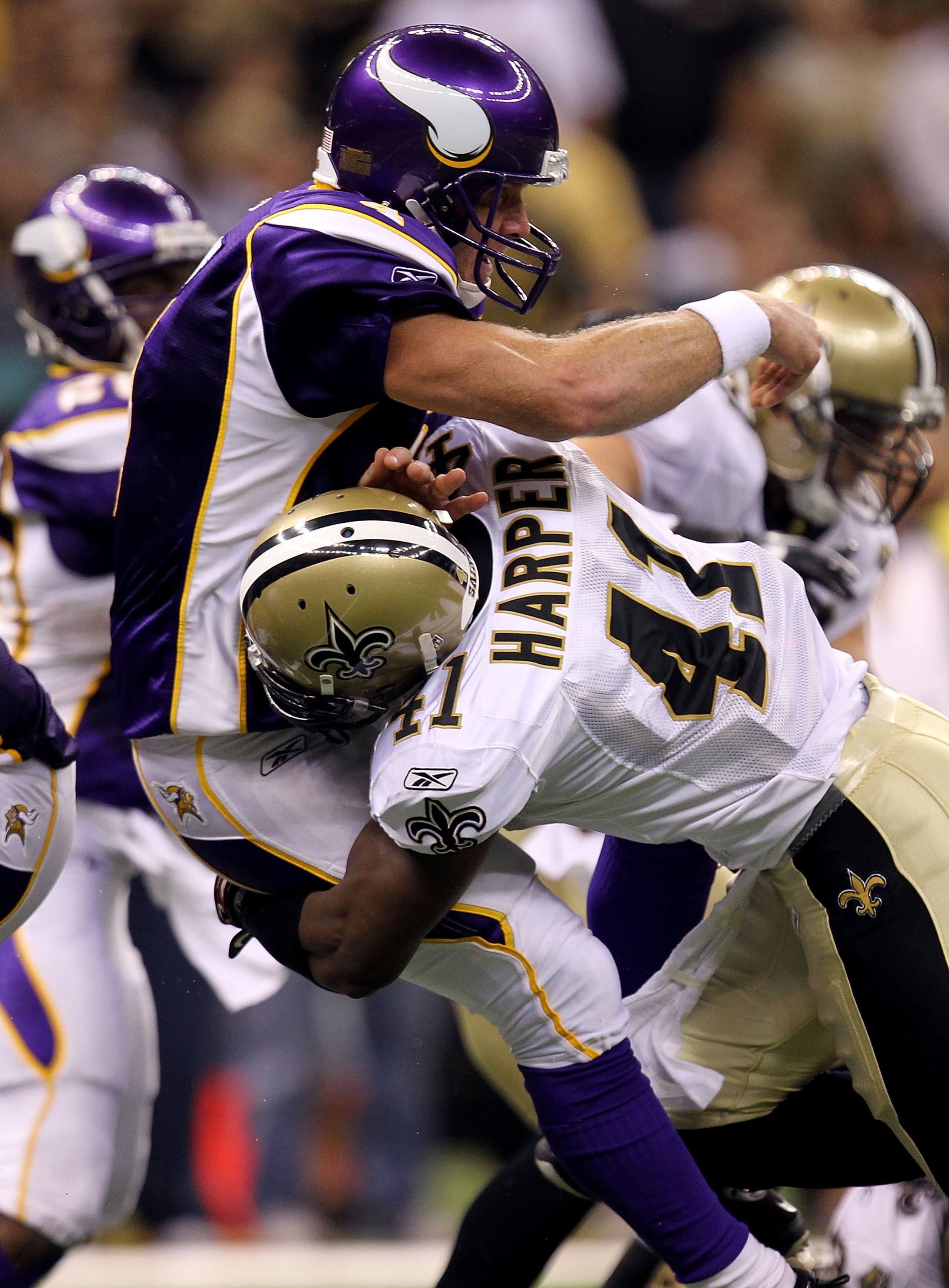 NEW ORLEANS - SEPTEMBER 09:  Quarterback Brett Favre #4 of the Minnesota Vikings takes a hard hit from Roman Harper #41 of the New Orleans Saints at Louisiana Superdome on September 9, 2010 in New Orleans, Louisiana.  (Photo by Ronald Martinez/Getty Image