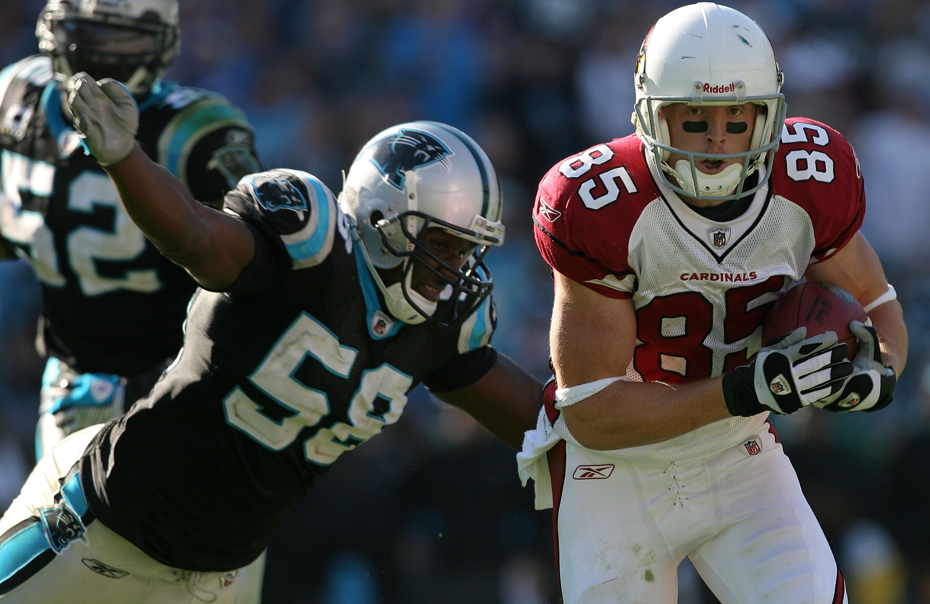 CHARLOTTE, NC - OCTOBER 26:  Jerheme Urban #85 of the Arizona Cardinals tries to run away from Thomas Davis #58 of the Carolina Panthers during their game  on October 26, 2008 at Bank of America Stadium in Charlotte, North Carolina.  (Photo by Streeter Le
