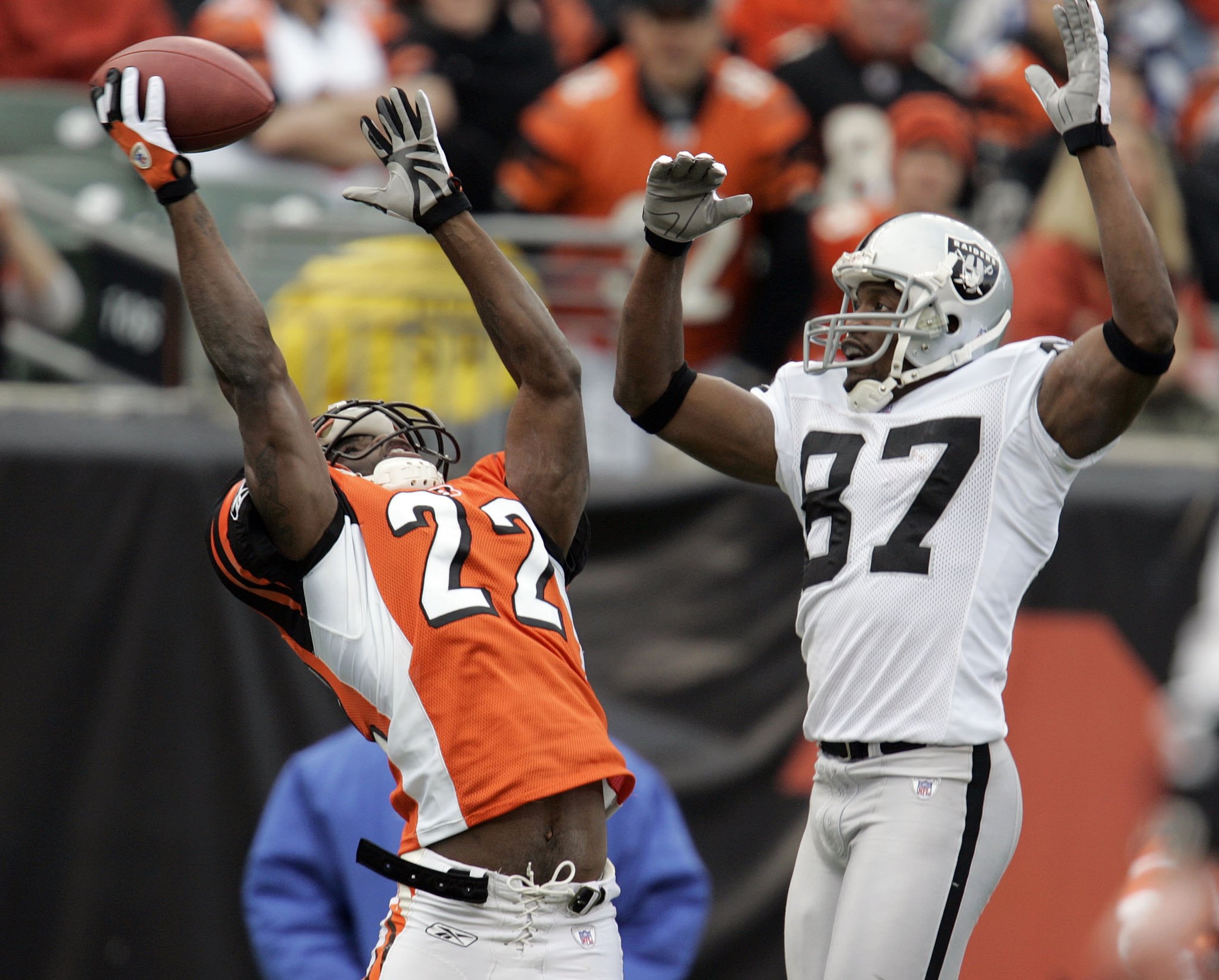 CINCINNATI, OH - DECEMBER 10:  Jonathan Joseph #22 of the Cincinnati Bengals almost intercepts a pass intended for Alvis Whitted #87 of the Oakland Raiders during the second quarter on December 10, 2006 at Paul Brown Stadium in Cincinnati, Ohio.  The Beng
