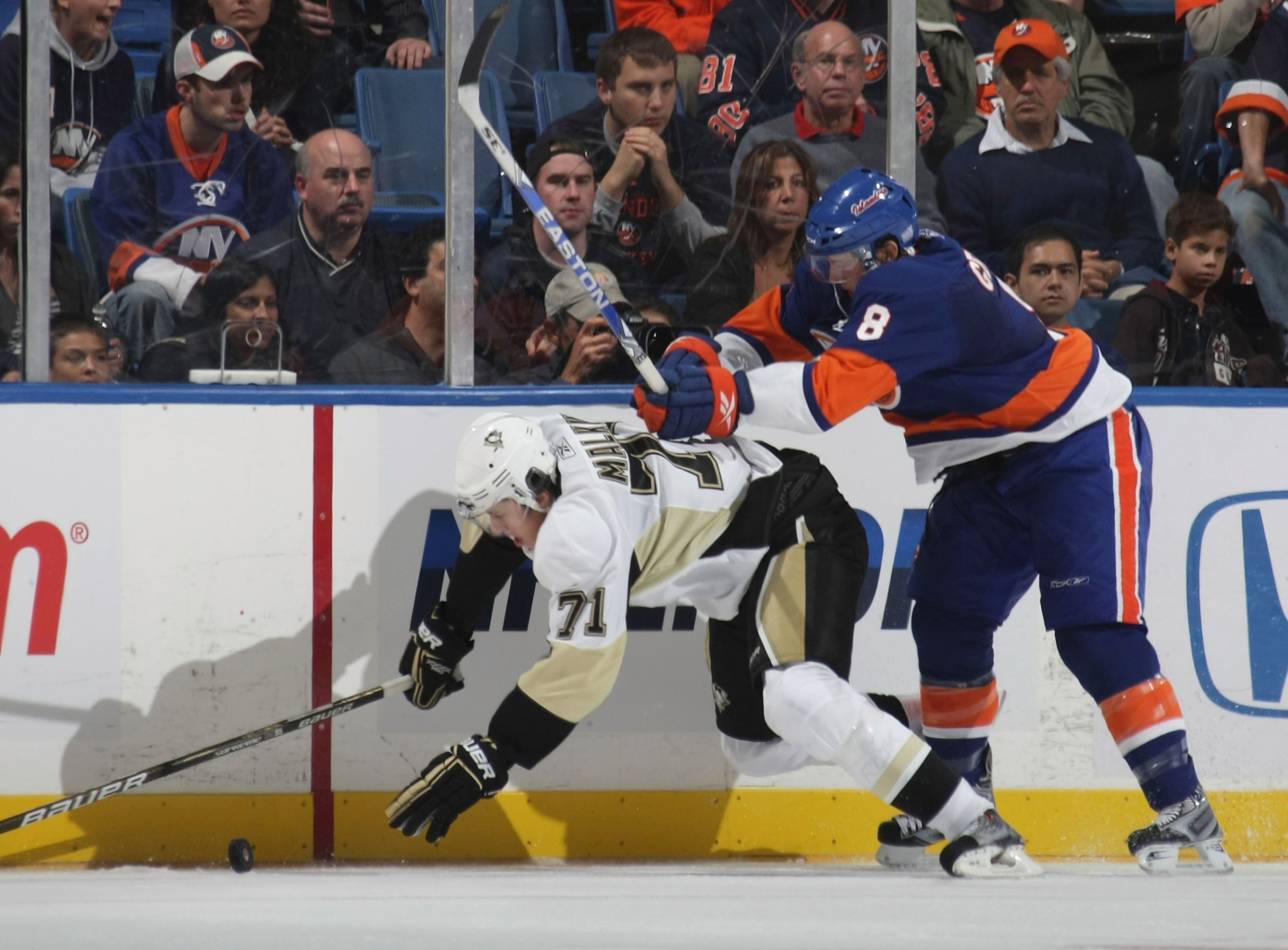 UNIONDALE, NY - OCTOBER 03: Evengi Malkin #71 of the Pittsburgh Penguins is hit by Bruno Gervais #8 of the New York Islanders at the Nassau Coliseum on October 3, 2009 in Uniondale, New York. (Photo by Bruce Bennett/Getty Images)