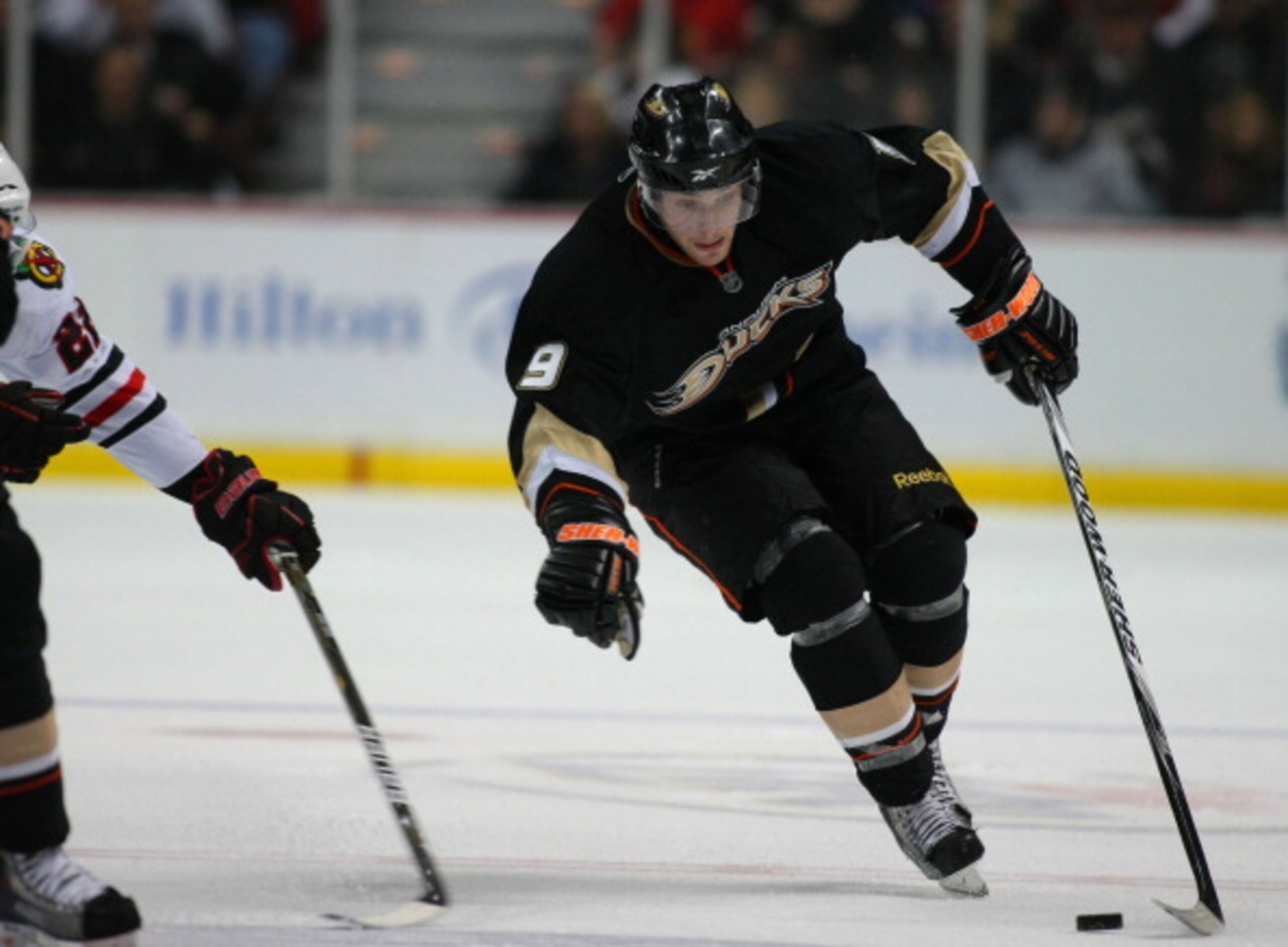 ANAHEIM, CA - JANUARY 02:  Bobby Ryan #9 of the Anaheim Ducks protects the puck from a poke check as he plays the puck through the neutral zone against the Chicago Blackhawks during the NHL game at Honda Center on January 2, 2011 in Anaheim, California. T