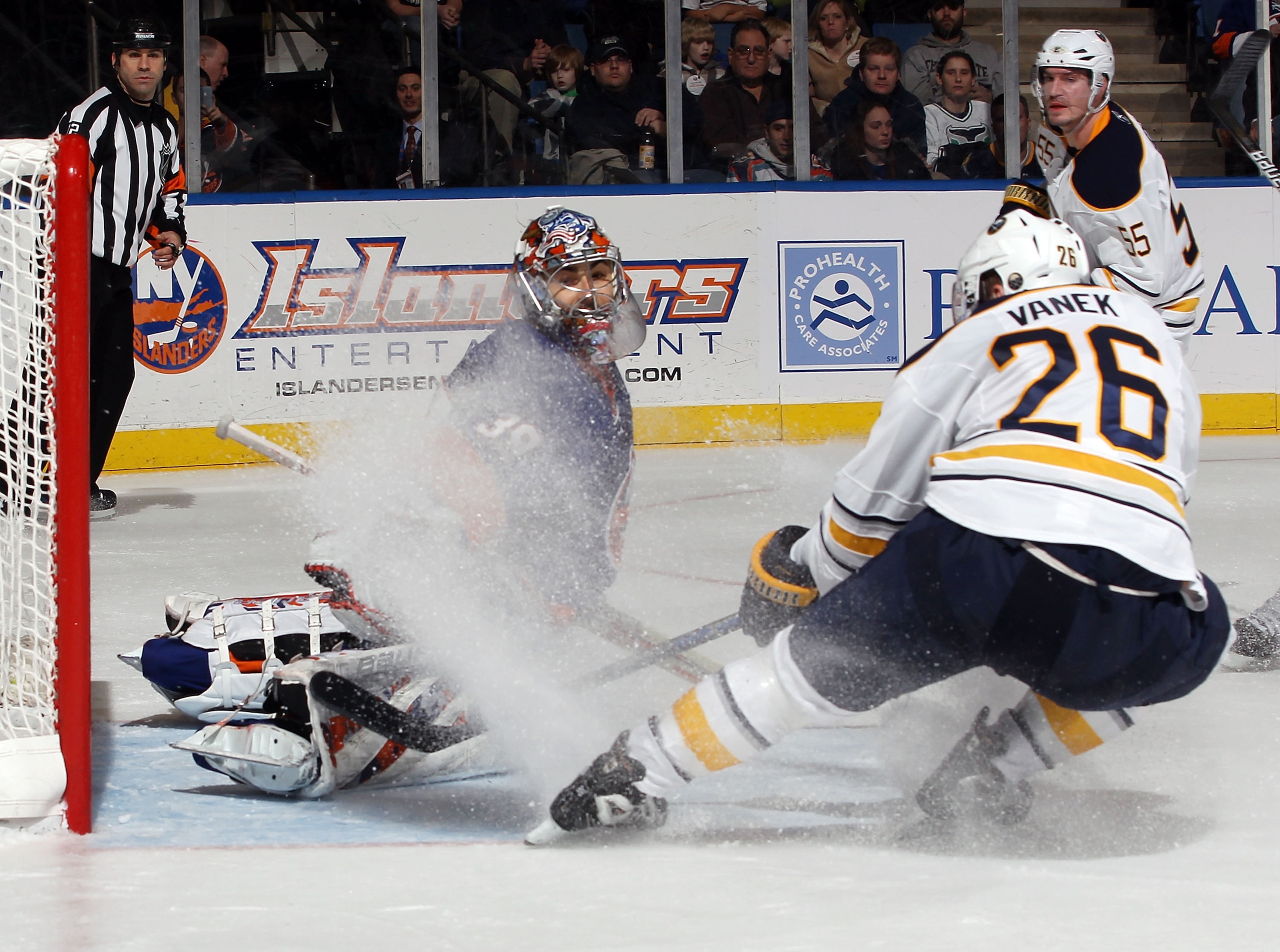 UNIONDALE, NY - JANUARY 15:  Rick DiPietro #39 of the New York Islanders makes the stop on Thomas Vanek #26 of the Buffalo Sabres at the Nassau Coliseum on January 15, 2011 in Uniondale, New York. The Islanders defeated the Sabres 5-3. (Photo by Bruce Ben