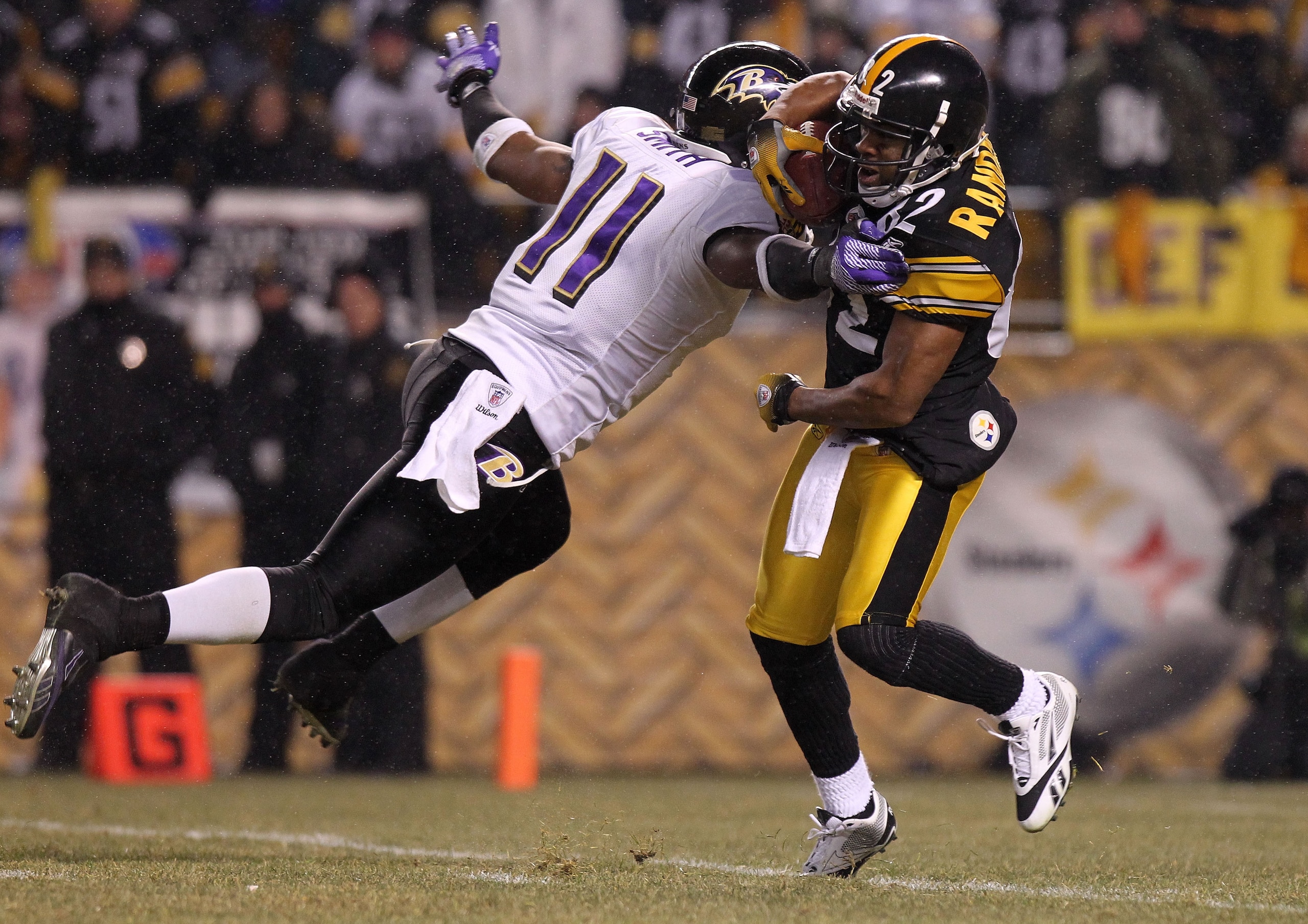PITTSBURGH, PA - JANUARY 15:  Marcus Smtih #11 of the Baltimore Ravens tackles Antwaan Randle El #82 of the Pittsburgh Steelers during a kick return in the AFC Divisional Playoff Game at Heinz Field on January 15, 2011 in Pittsburgh, Pennsylvania.  (Photo