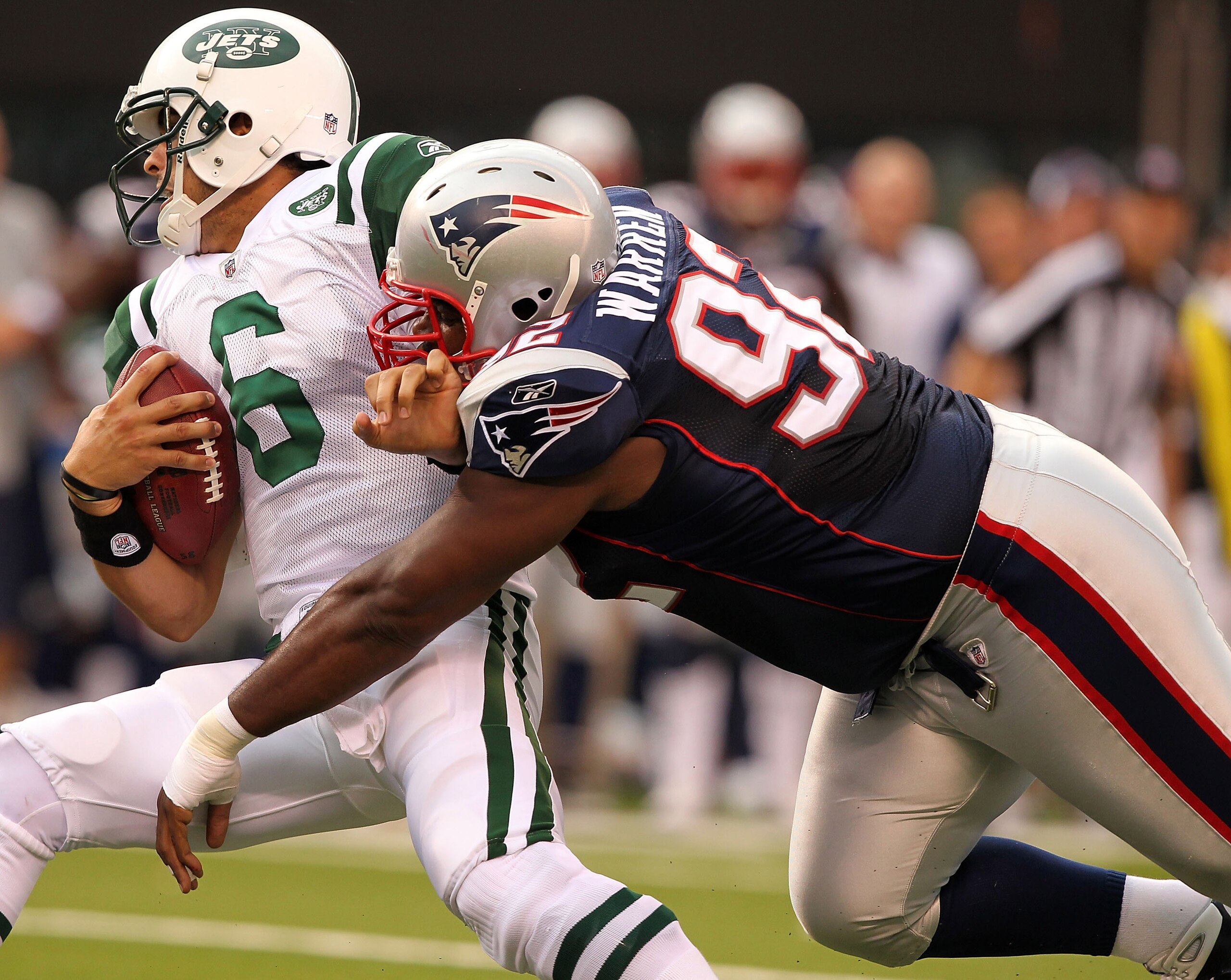 EAST RUTHERFORD, NJ - SEPTEMBER 19:  Mark Sanchez #6  of the New York Jets is sacked by Gerard Warren #92 of the New England Patriots on September 19, 2010 at the New Meadowlands Stadium  in East Rutherford, New Jersey.  (Photo by Al Bello/Getty Images)
