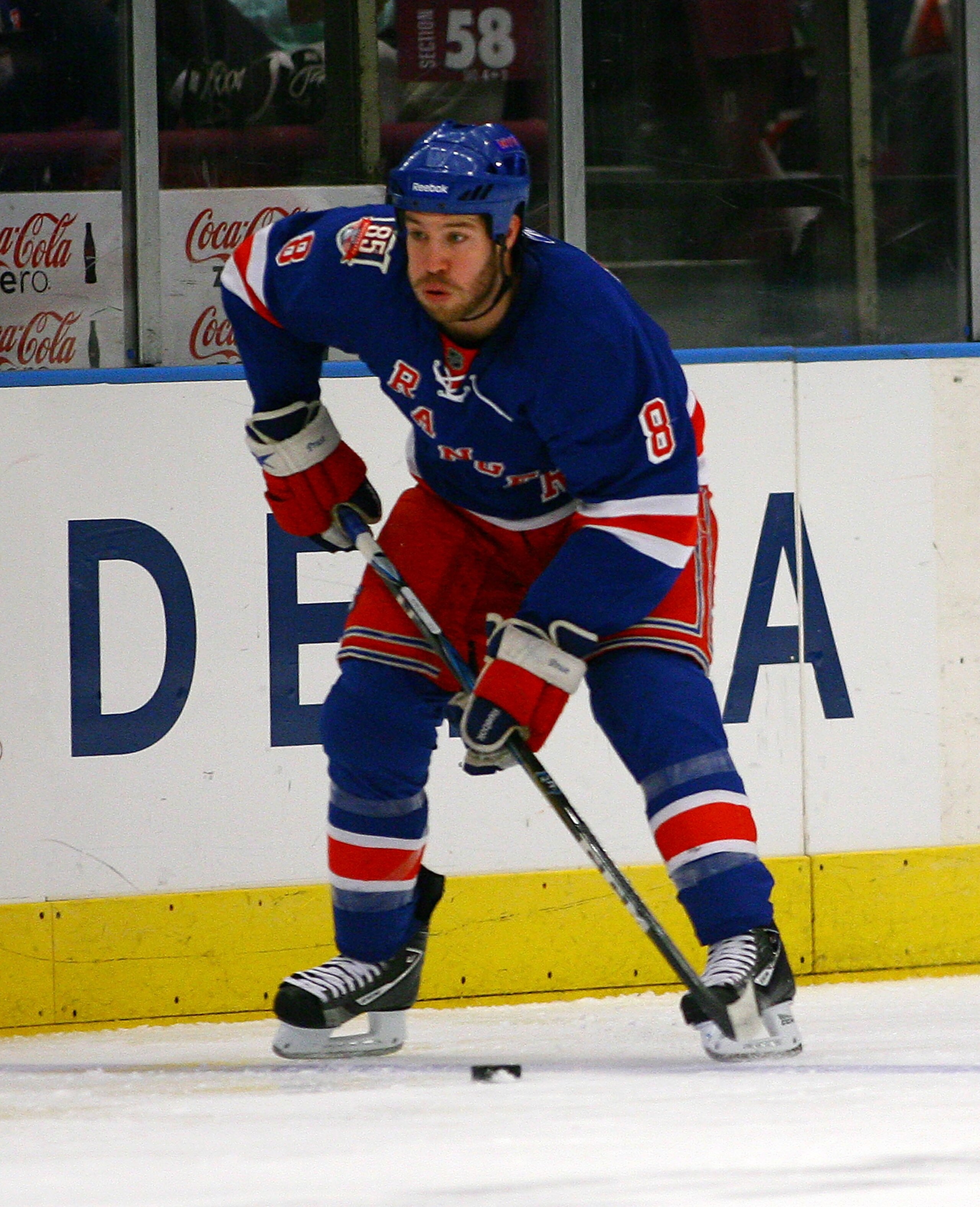 NEW YORK , NY - JANUARY 13: Brandon Prust #8 of the New York Rangers plays the puck against the Vancouver Canucks during the game at Madison Square Garden on January 13, 2011 in New York City. (Photo by Andy Marlin/Getty Images)