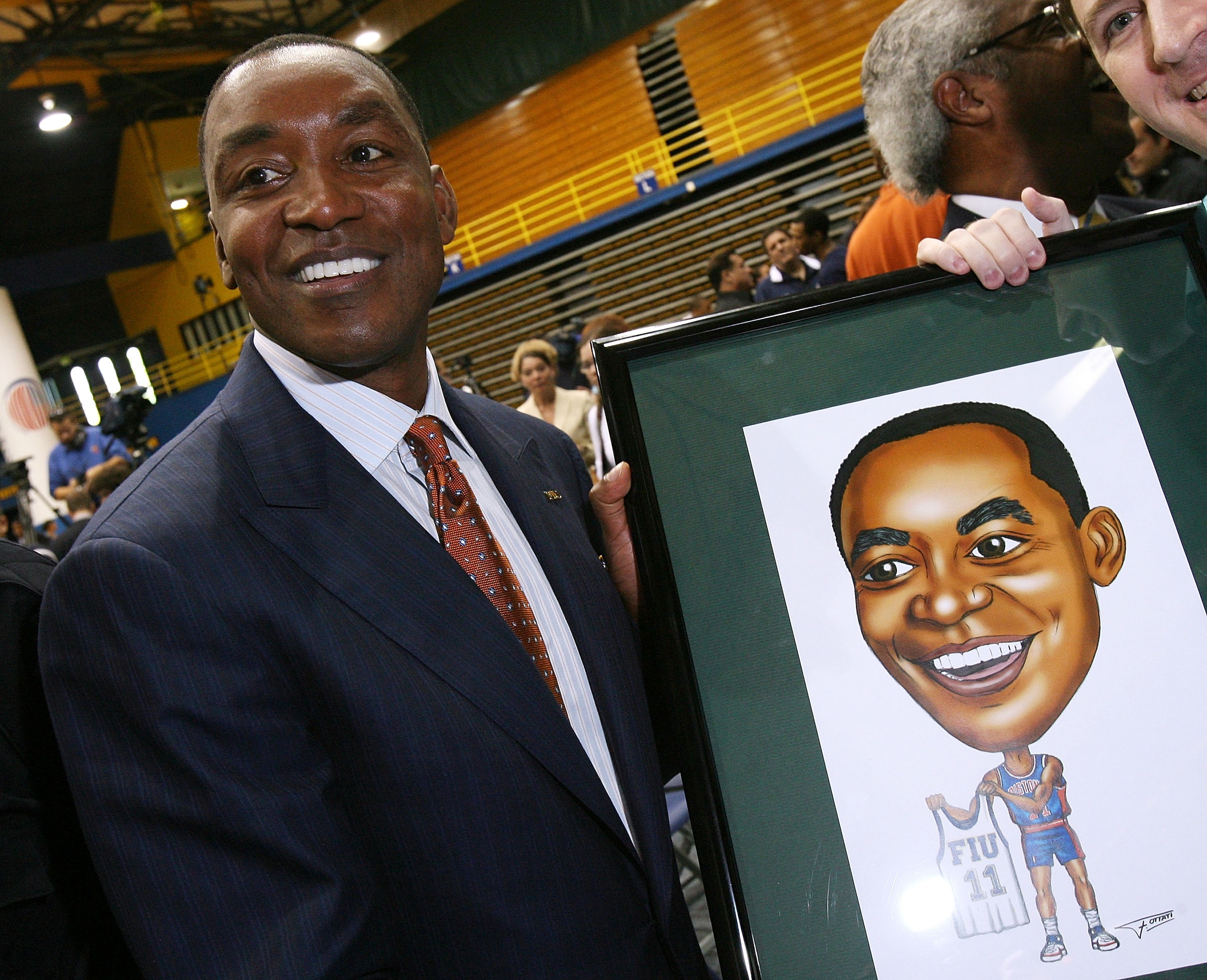 MIAMI - APRIL 15: Isiah Thomas is presented with artwork by Fernando Ottati after he was introduced as the new head coach for Florida International Univeristy men's basketball team at U.S.Century Bank Arena on April 15, 2009 in Miami, Florida. (Photo by MIAMI - APRIL 15: Isiah Thomas is presented with artwork by Fernando Ottati after he was introduced as the new head coach for Florida International Univeristy men's basketball team at U.S.Century Bank Arena on April 15, 2009 in Miami, Florida. (Photo by