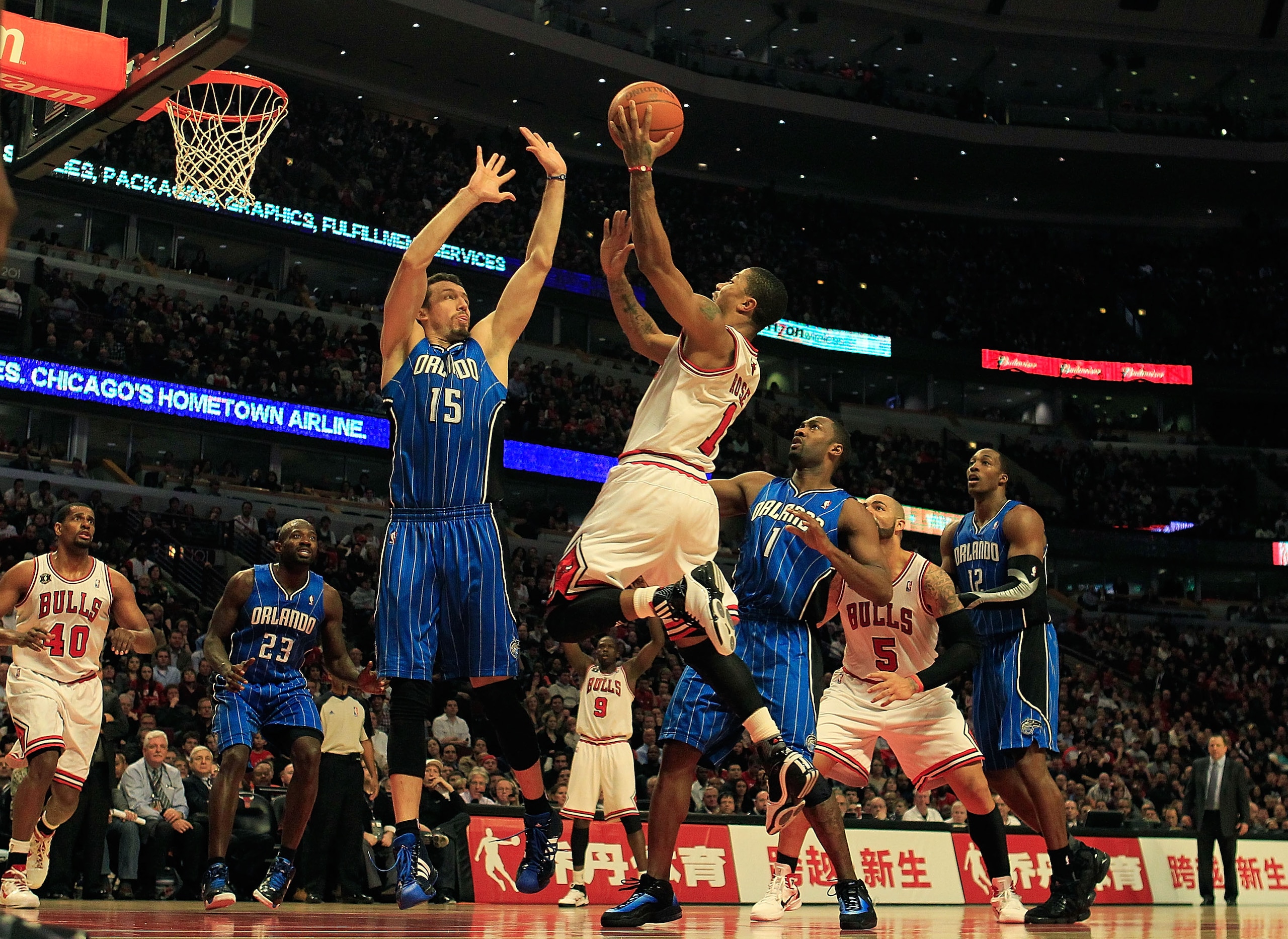 CHICAGO, IL - JANUARY 28: Derrick Rose #1 of the Chicago Bulls puts up a shot between Hedo Turkoglu #15 and Gilbert Arenas #1 of the Orlando Magic at the United Center on January 28, 2011 in Chicago, Illinois. The Bulls defeated the Magic 99-90. NOTE TO U