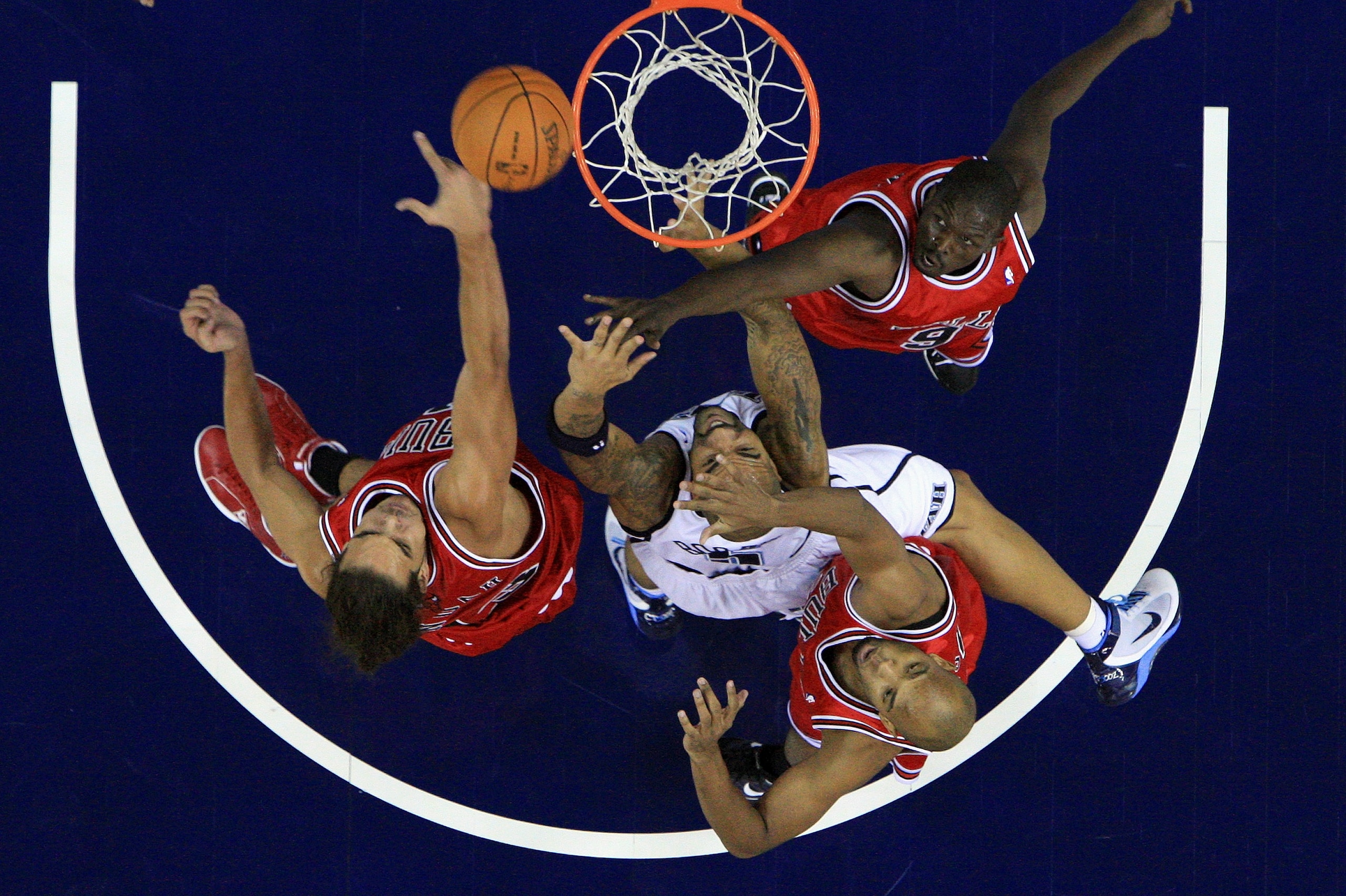 LONDON, ENGLAND - OCTOBER 06:  Taj Gibson (#22), Luol Deng (#9) and Joakim Noah (#13) of the Chicago Bulls battle for the rebound with Carlos Boozer (#5) of the Utah Jazz during the NBA pre-season game as part of the 2009 NBA Europe Live Tour between Chic