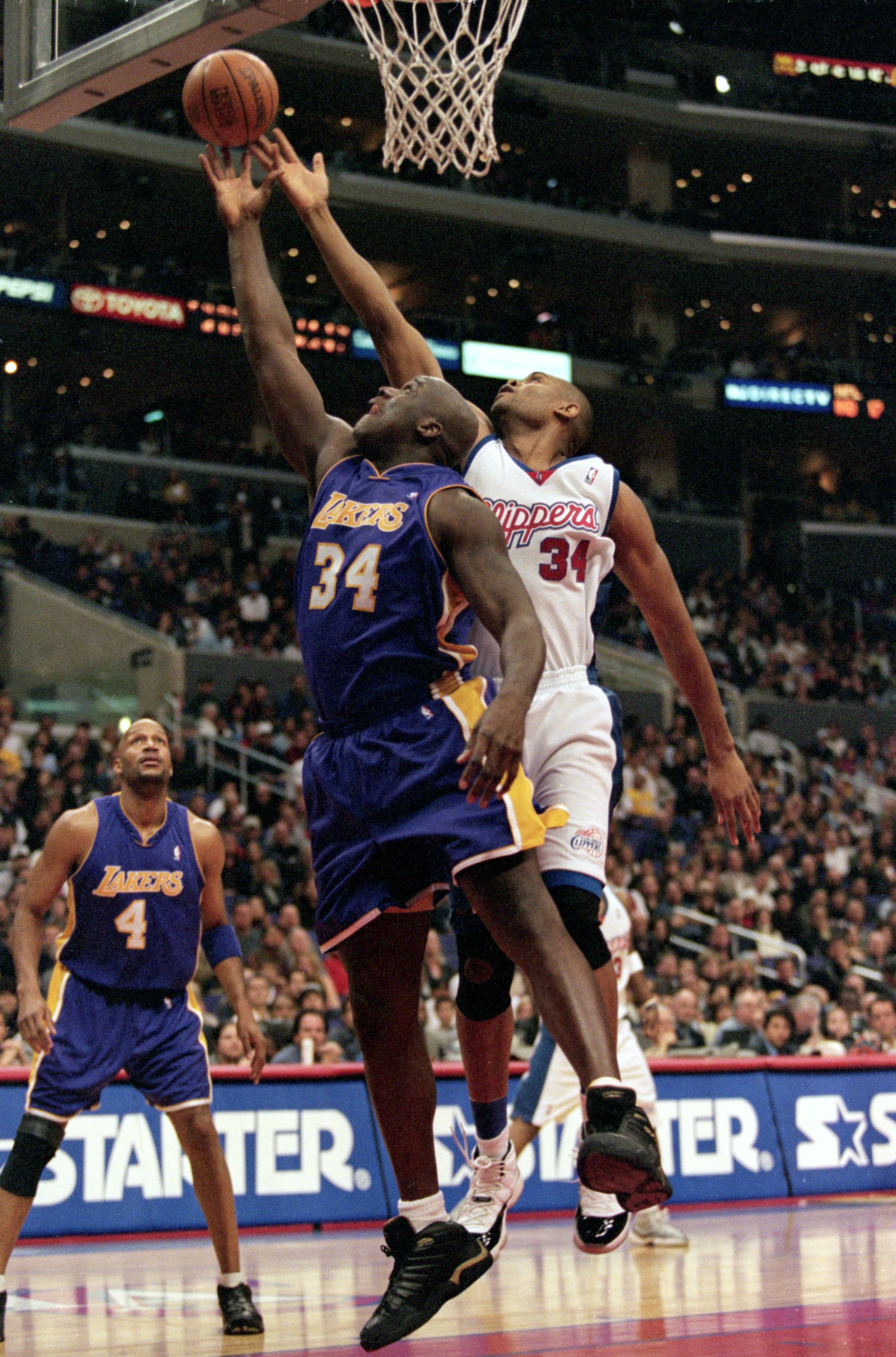 30 Dec 2000:  Shaquille O''Neal #34 of the Los Angeles Lakers and  Michael Olowokandi #34 of the Los Angeles Clippers jump for the ball by the net during the game at the STAPLES Center in Los Angeles, California.  The Lakers defeated the Clippers 116-114.