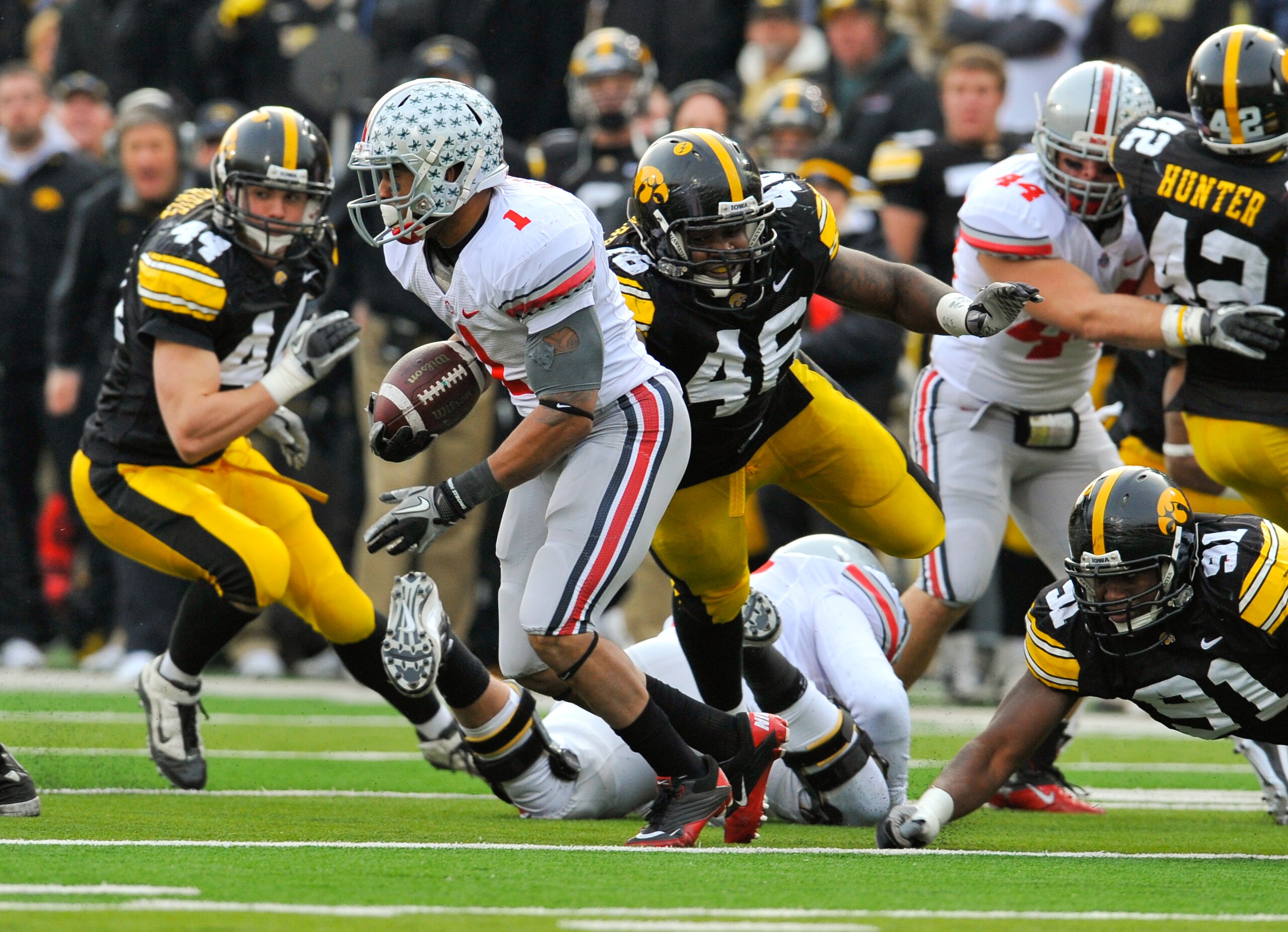 IOWA CITY, IA - NOVEMBER 20: Tailback Dan Herron #1 of the Ohio State Buckeyes scrambles for yards past defensive end Christian Ballard $46 of the University of Iowa Hawkeyes during the second half of play at Kinnick Stadium on November 20, 2010 in Iowa IOWA CITY, IA - NOVEMBER 20: Tailback Dan Herron #1 of the Ohio State Buckeyes scrambles for yards past defensive end Christian Ballard $46 of the University of Iowa Hawkeyes during the second half of play at Kinnick Stadium on November 20, 2010 in Iowa